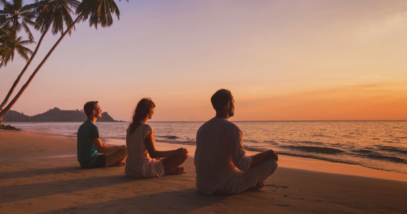 Yoga retreat on the beach at sunset