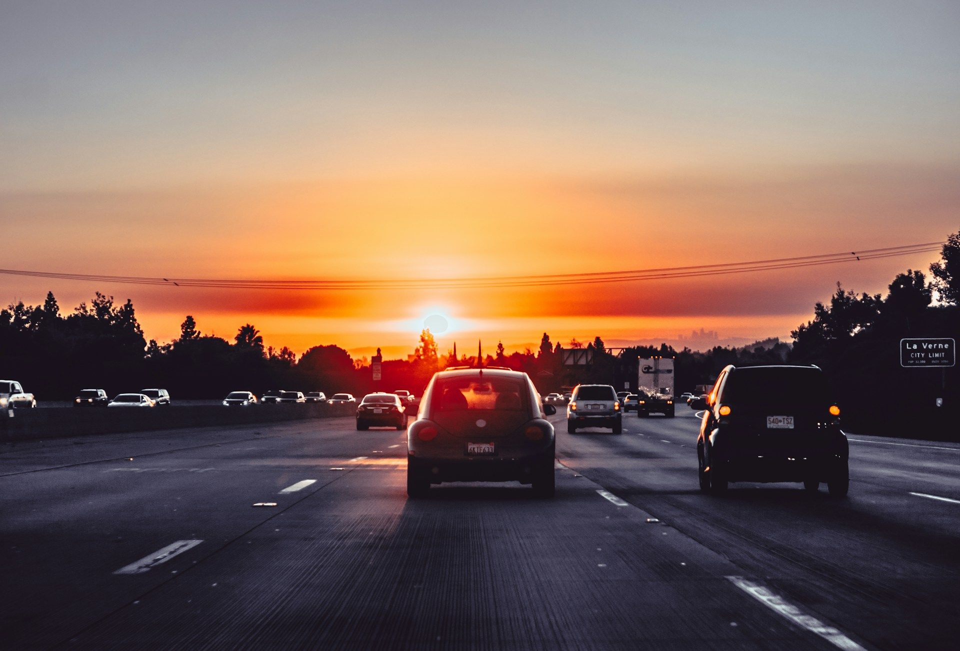 Cars on a freeway in California at sunset