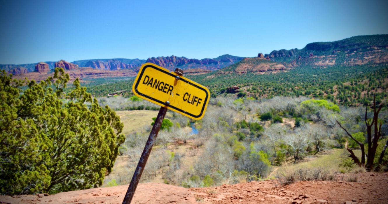 A yellow warning sign on a hiking trail in Sedona, Arizona