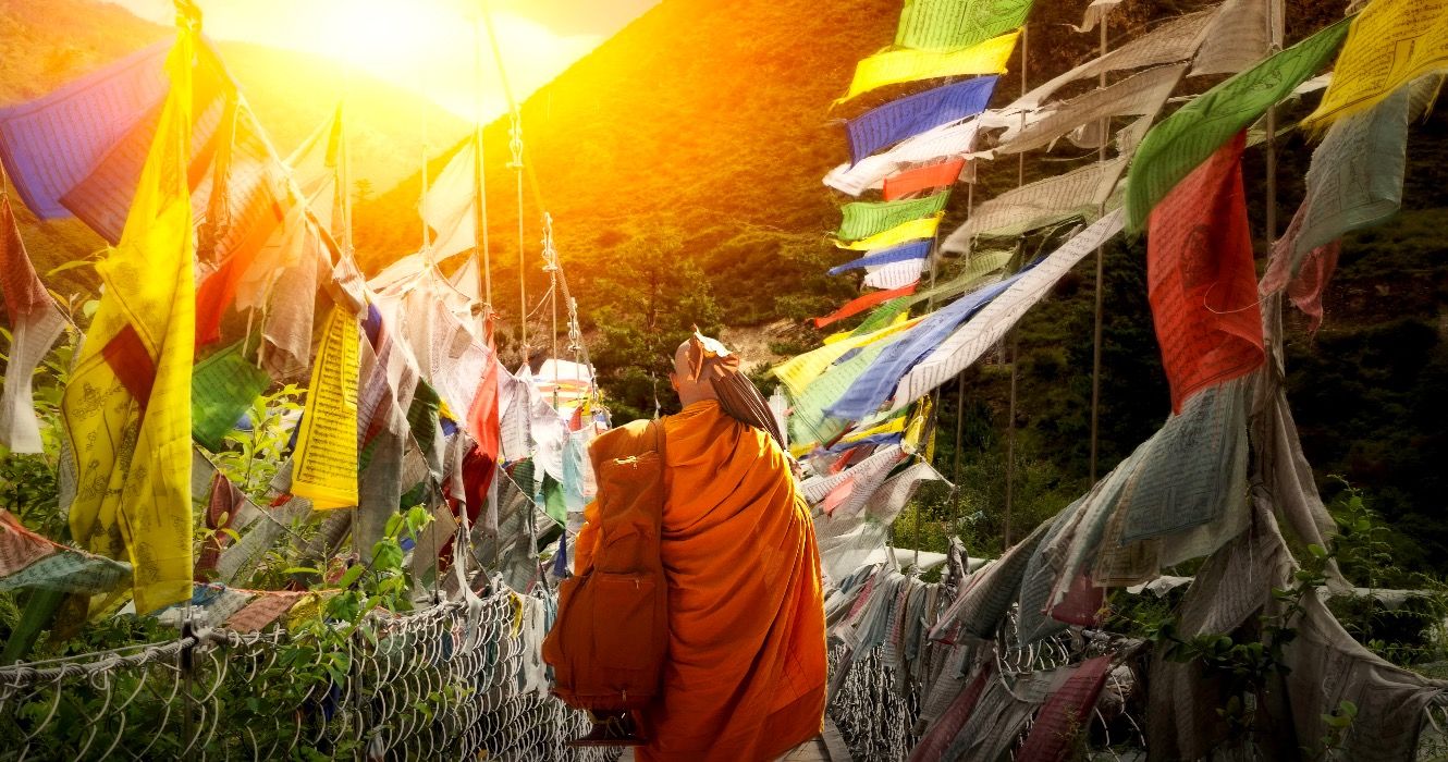 A monk hikes a narrow path in Bhutan