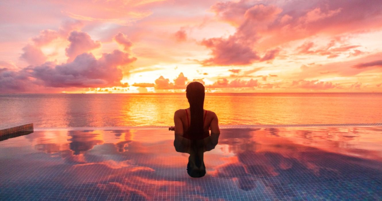 Woman at a resort in the Caribbean at sunset