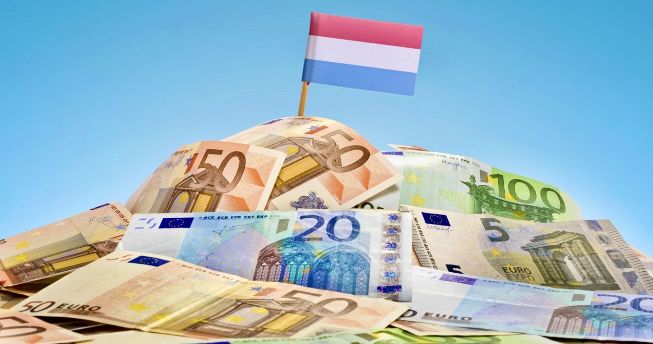 The national flag of Luxembourg sticking in a pile of mixed european banknotes