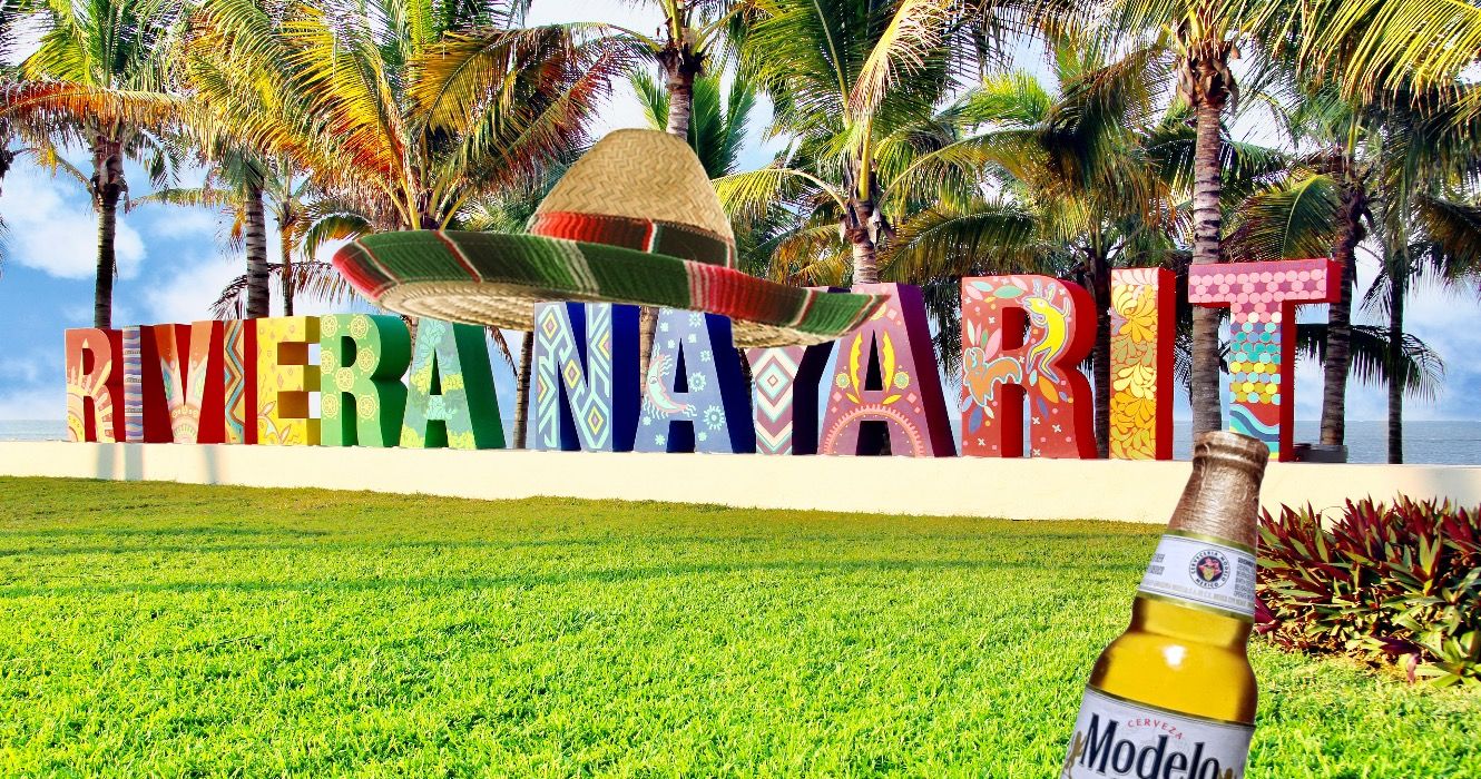 Colorfully painted Riviera Nayarit sign on a public beach in Mexico.