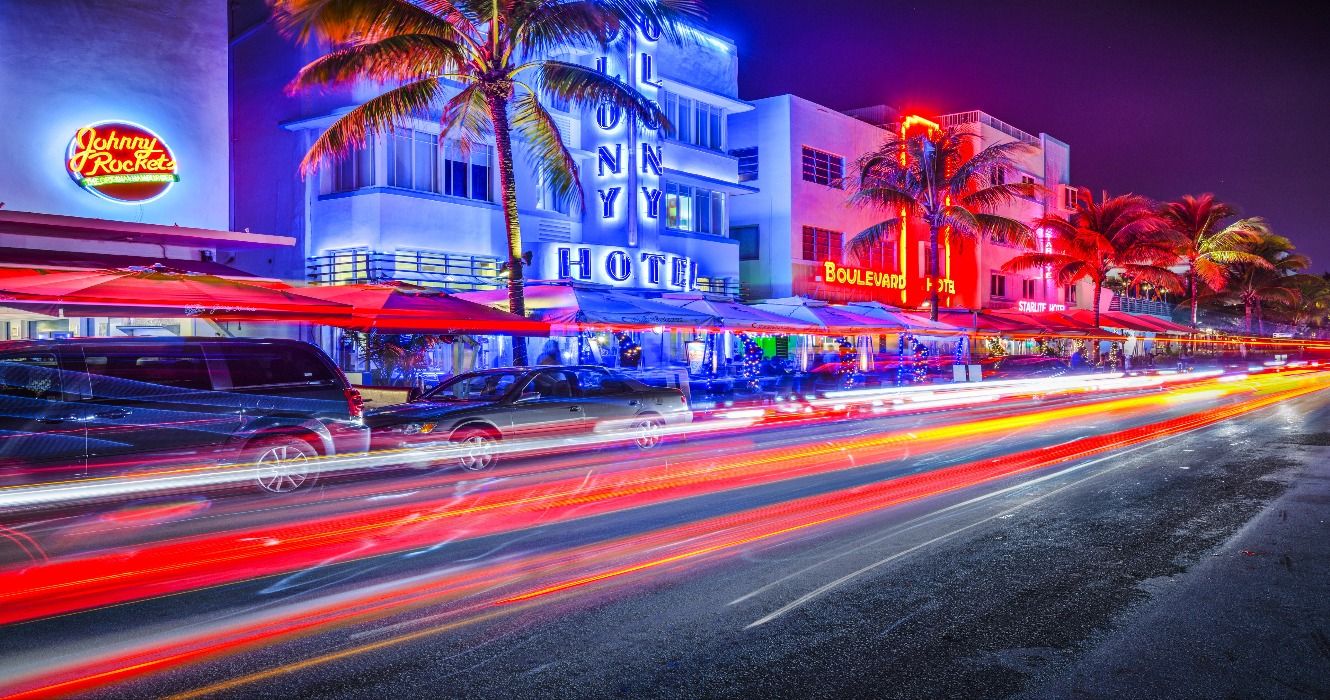 Cars driving along Ocean Drive through South Beach at night in Miami, FL, Florida, USA