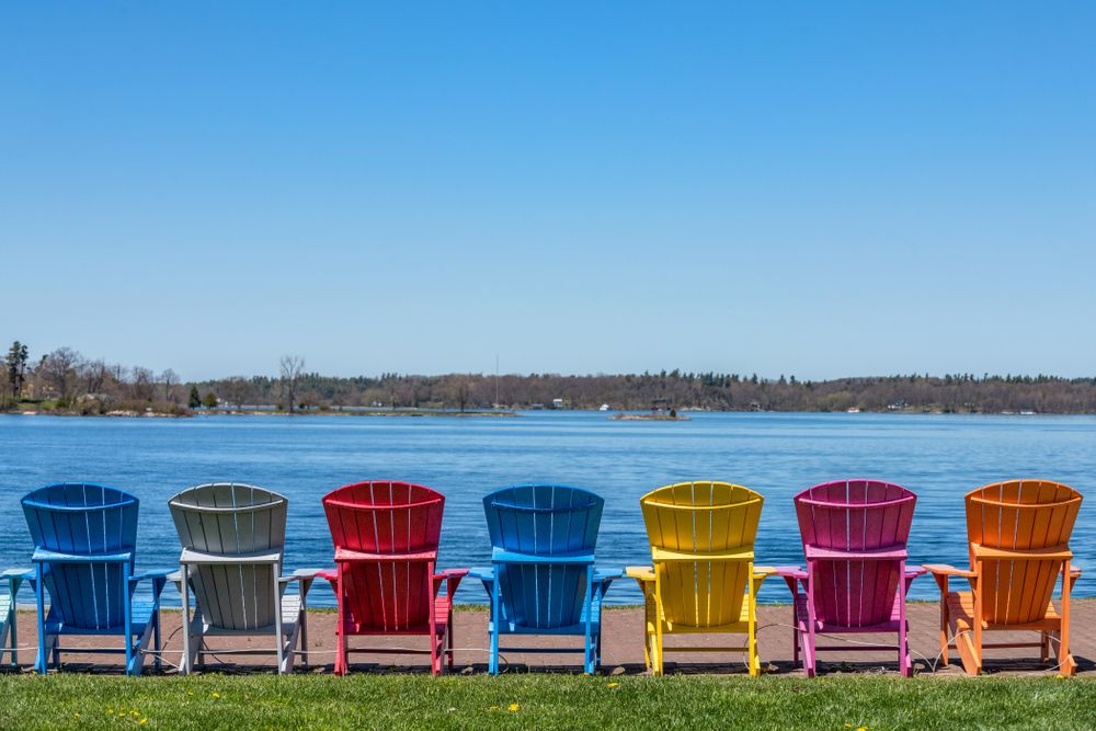 Adirondack chairs along the waterfront on the St. Lawrence River in Clayton, New York, NY, USA
