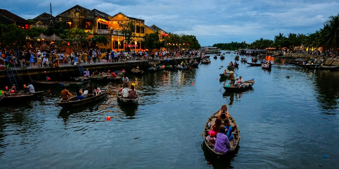 People riding on a boat in a river in Da Nang, Vietnam