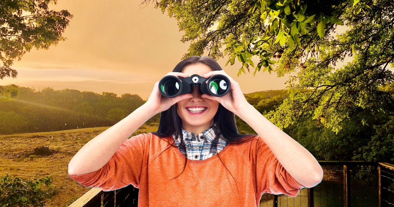 Woman looking into binoculars in Kerrville, Texas