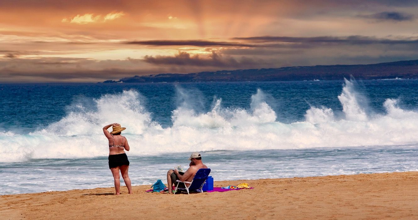 Middle age man and woman relaxing on a beach on Molokai Hawaii