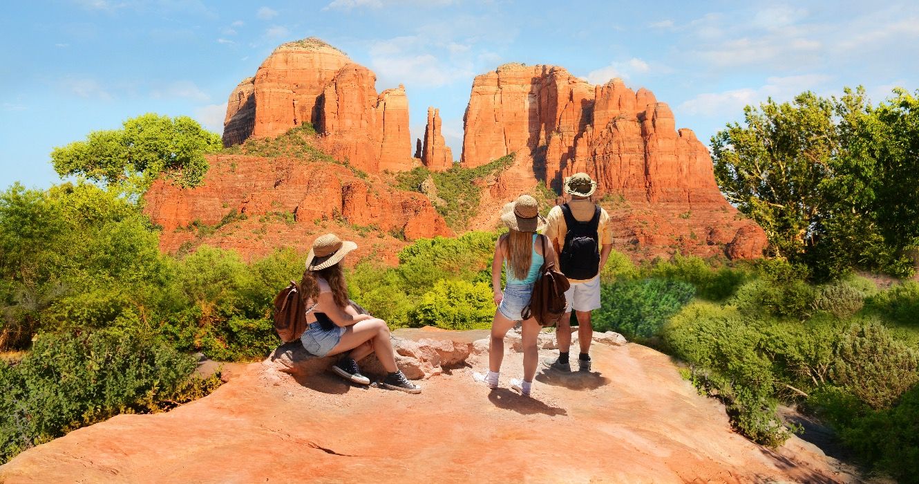 Family hiking to Cathedral Rock viewpoint in Sedona, Arizona