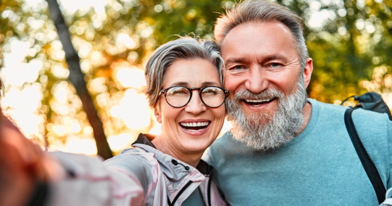 Happy retired couple smiling for selfie