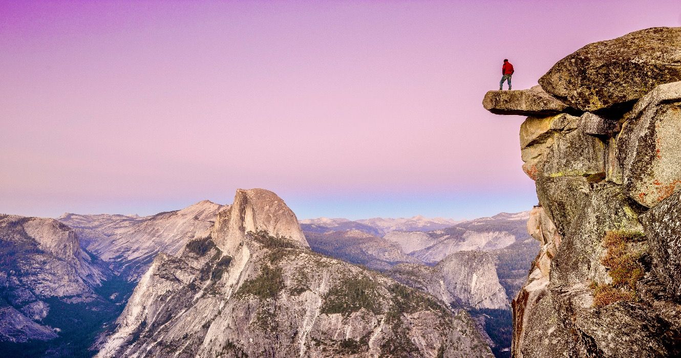 Male hiker overlooking cliff in Yosemite