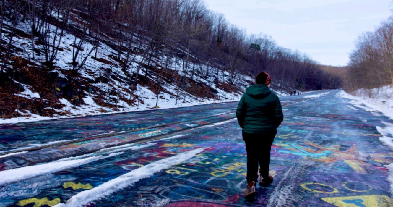 Woman walking along Centralia graffiti highway alone