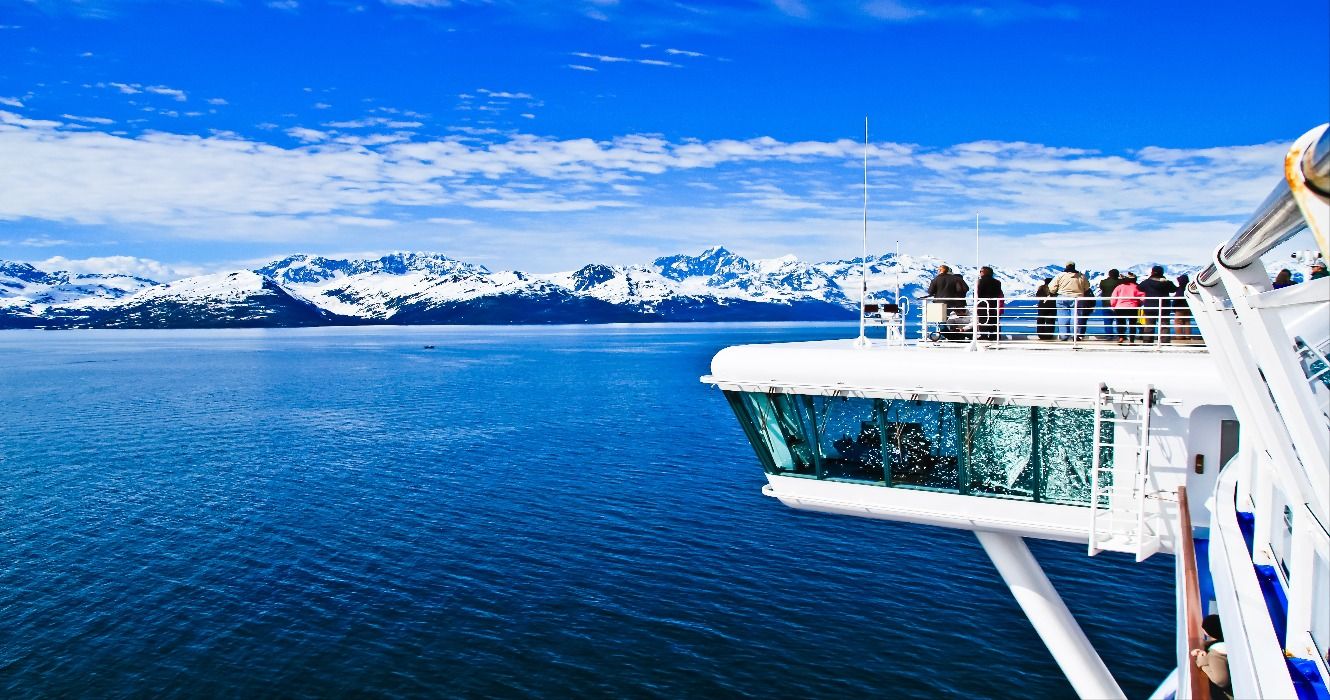 Snow-capped mountains and ocean seen from an Alaskan cruise ship in Alaska, USA