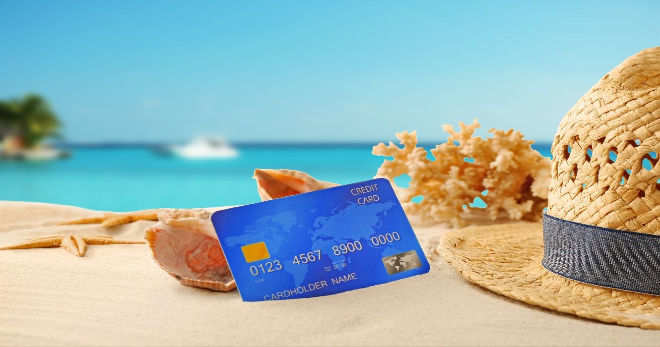 A travel credit card on a table at a sunny vacation destination