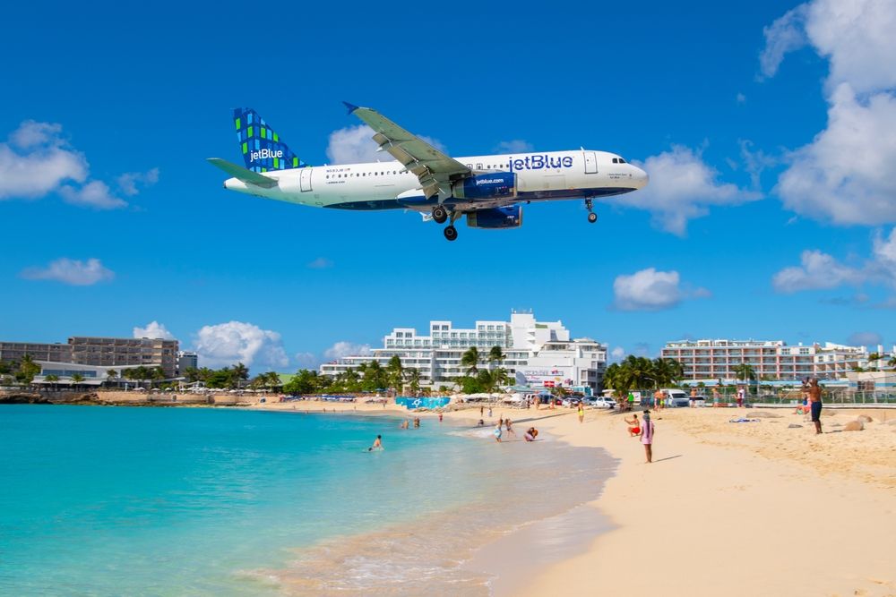 JetBlue Airways Airbus 320 flying over Maho Beach 