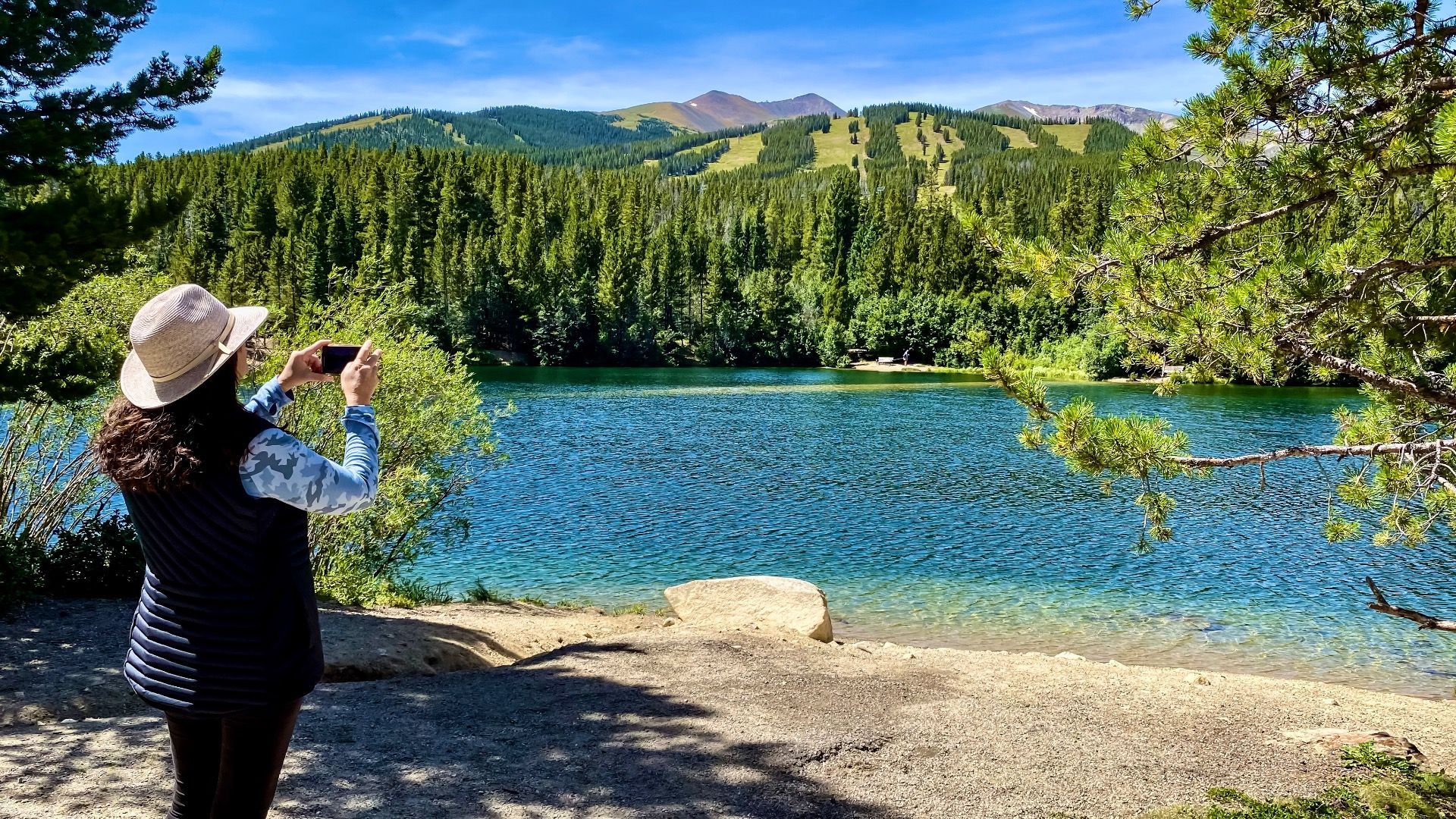 Hiker taking photos of Colorado Rockies