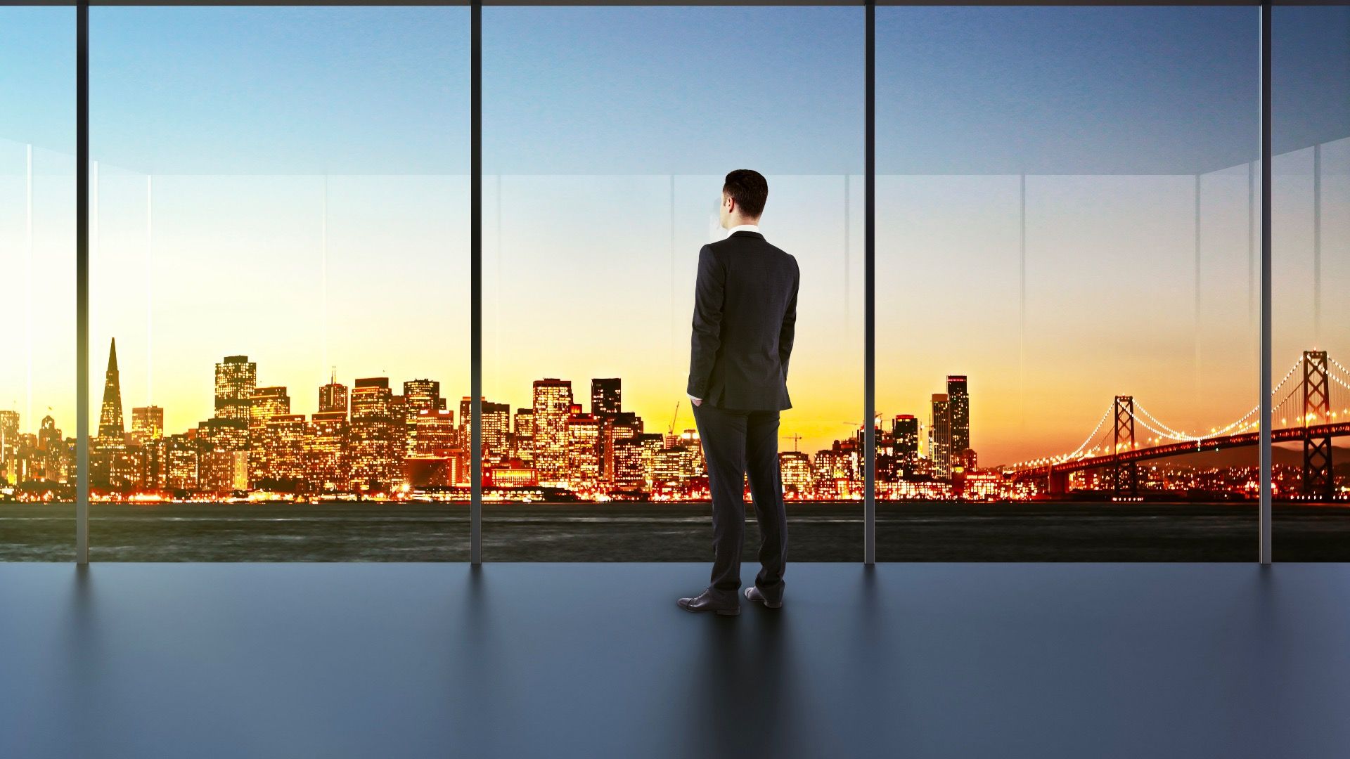 Businessman in empty office looking at beautiful skyline