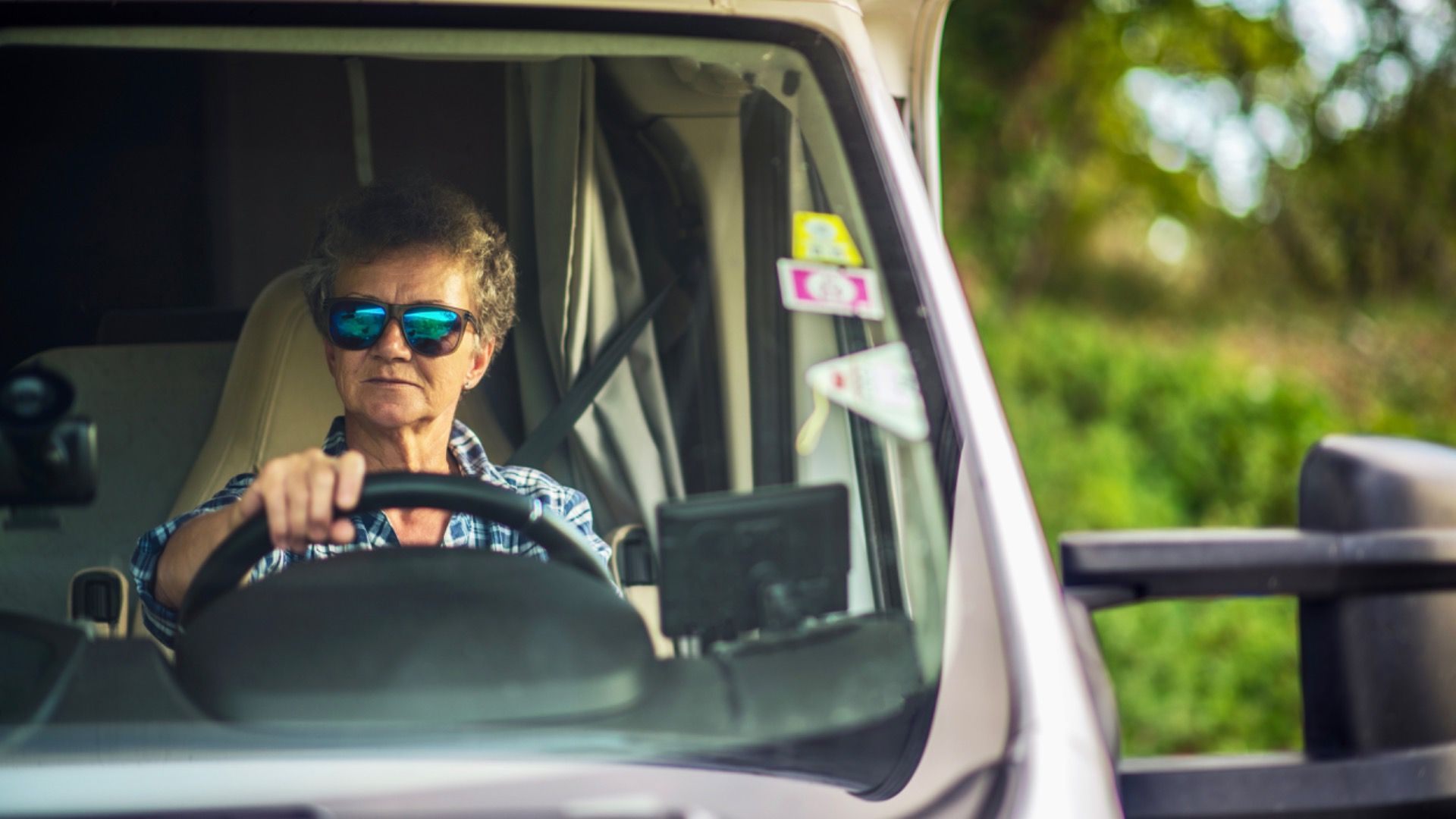 Retired Woman in Her 60s Driving Class C Motorhome. Summer Road Trip.