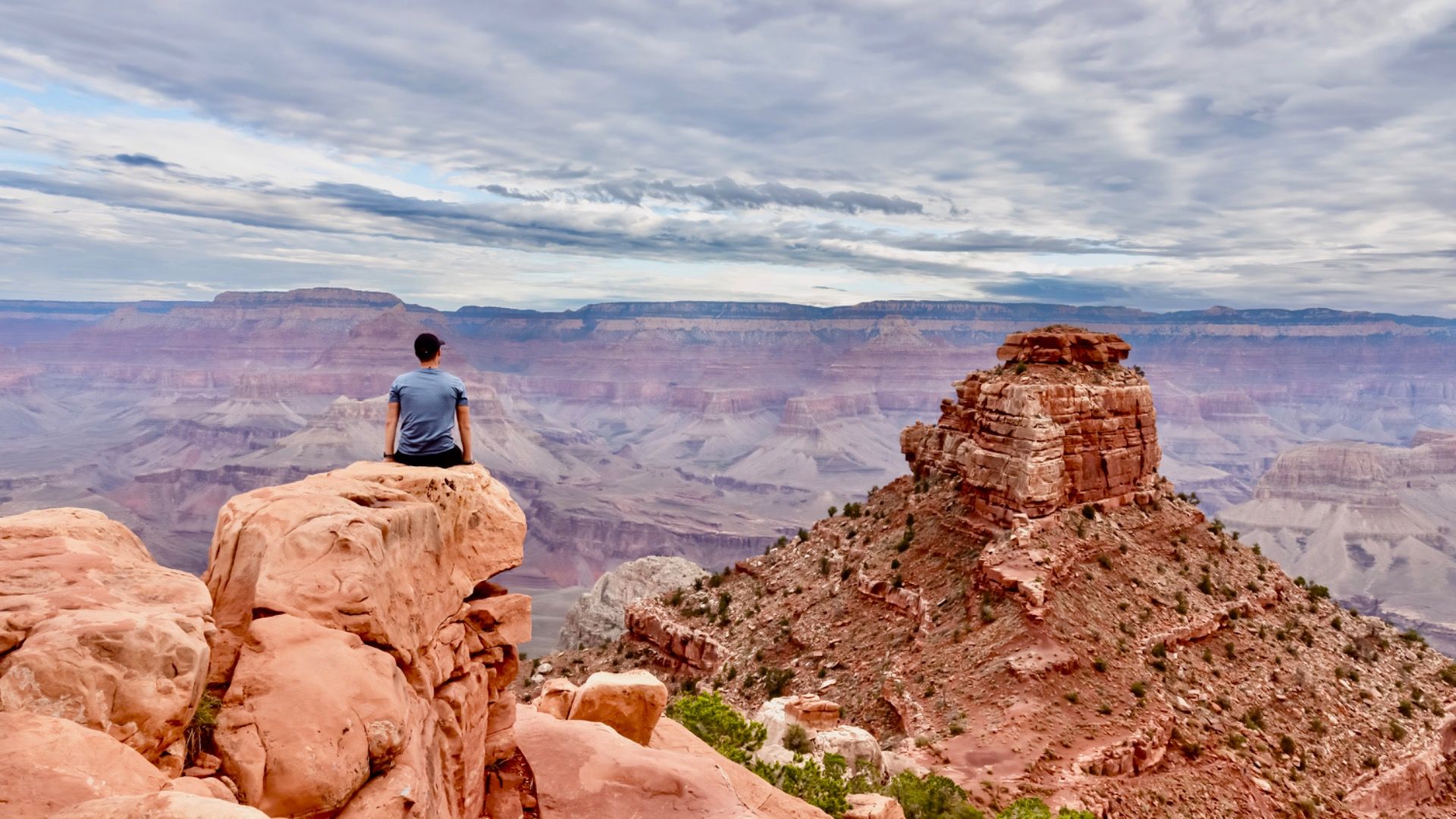 Man with scenic view from Skeleton Point on South Kaibab hiking trail at South Rim, Grand Canyon 