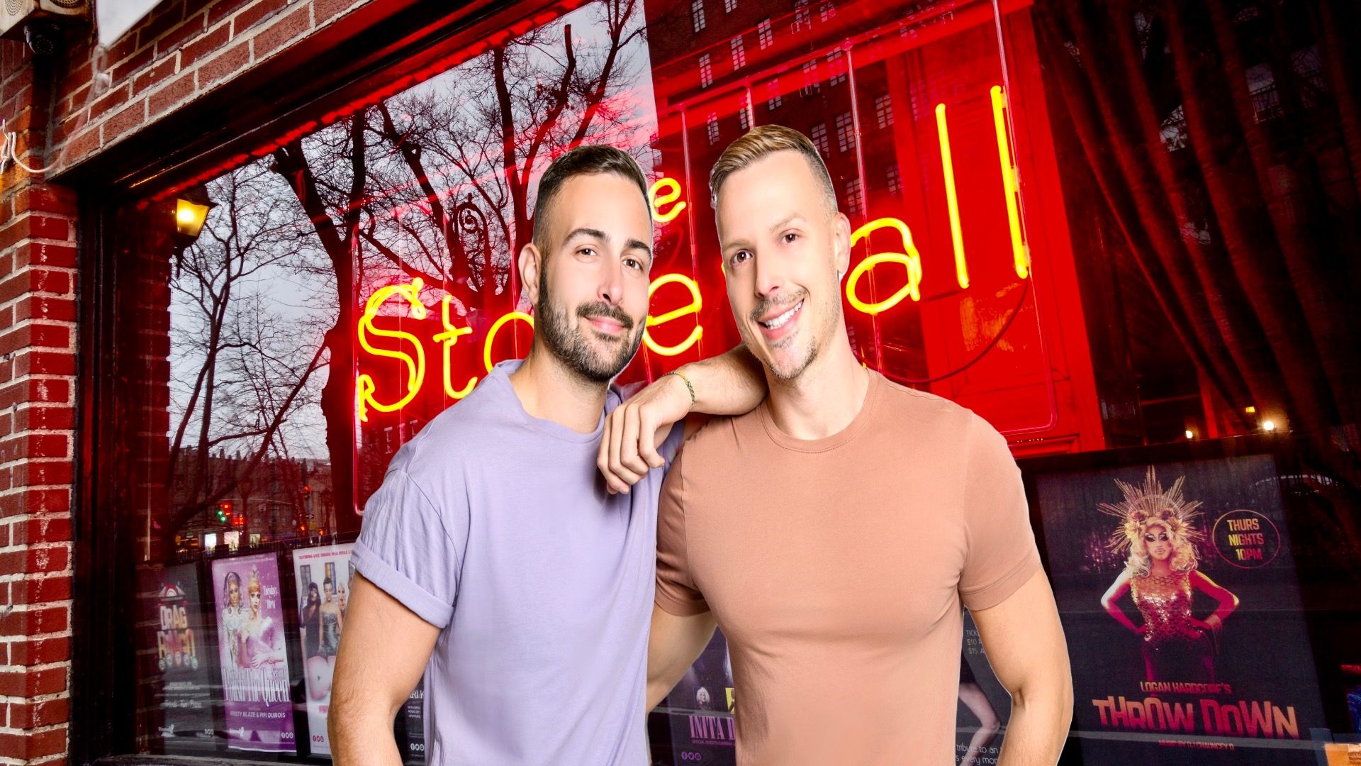 Couple stands in front of the iconic Stonewall Inn, NYC