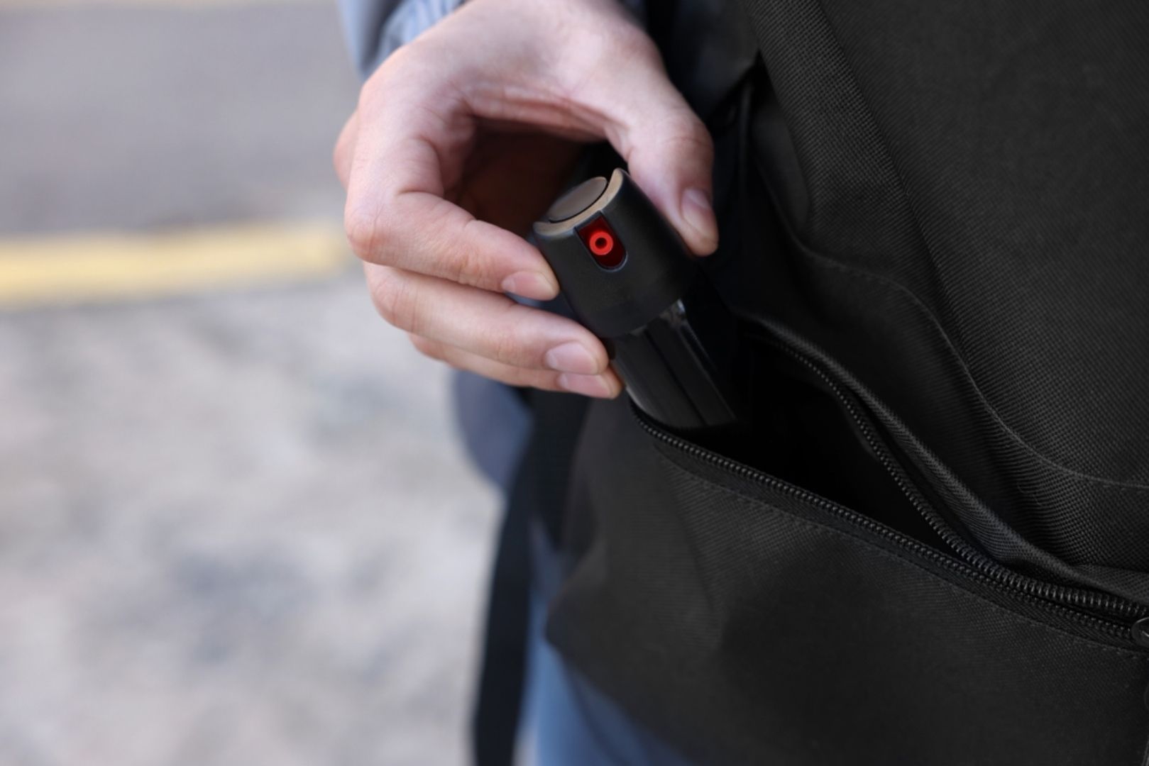 Person taking pepper spray out of a bag