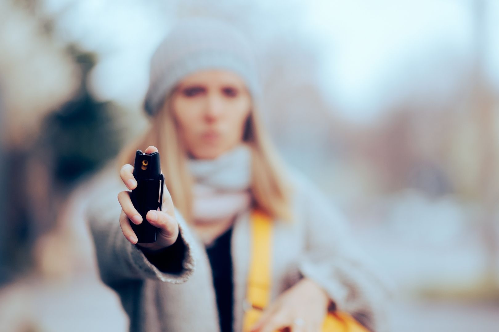 Woman holding pepper spray