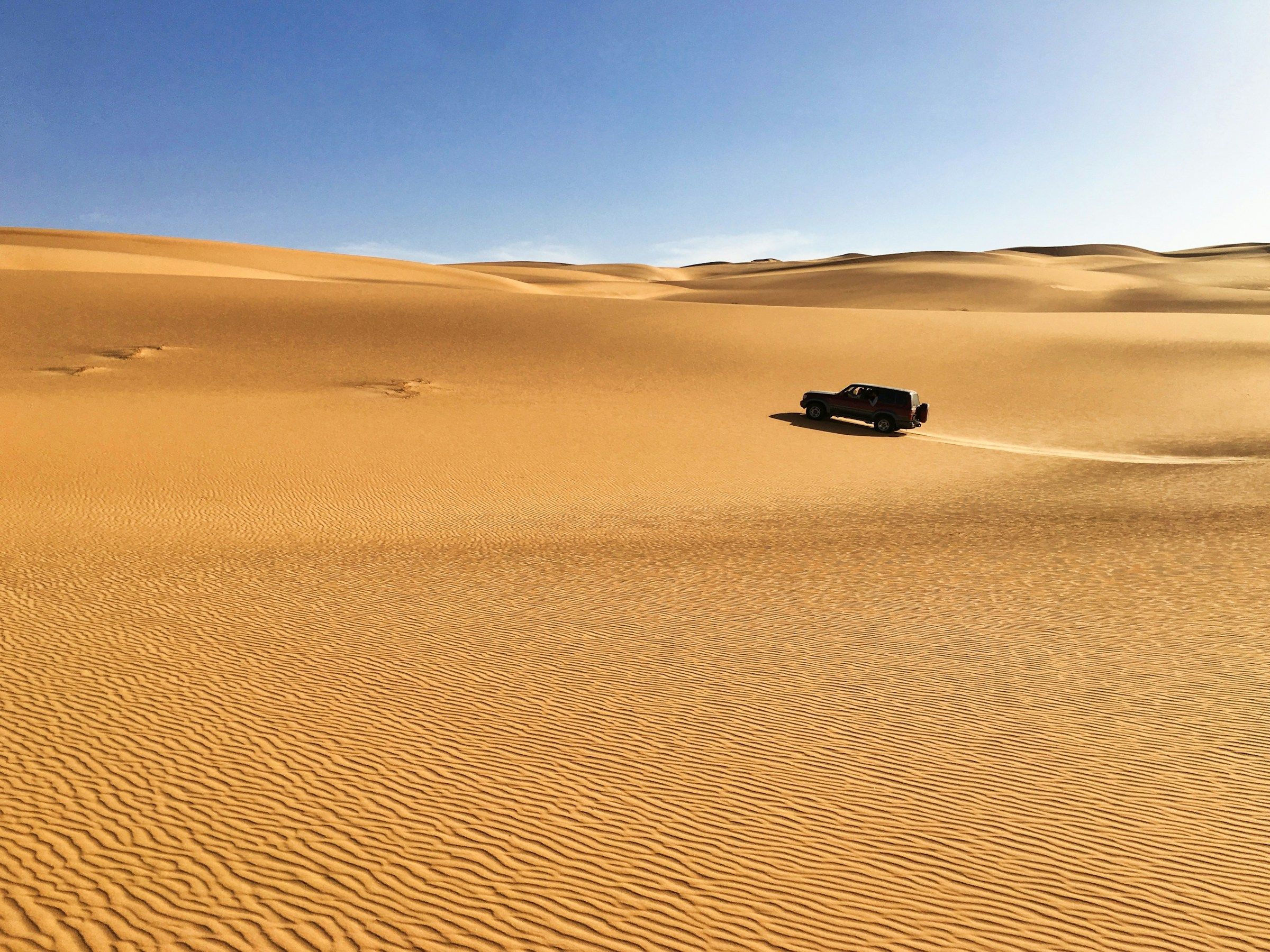 Car driving in the desert in Libya