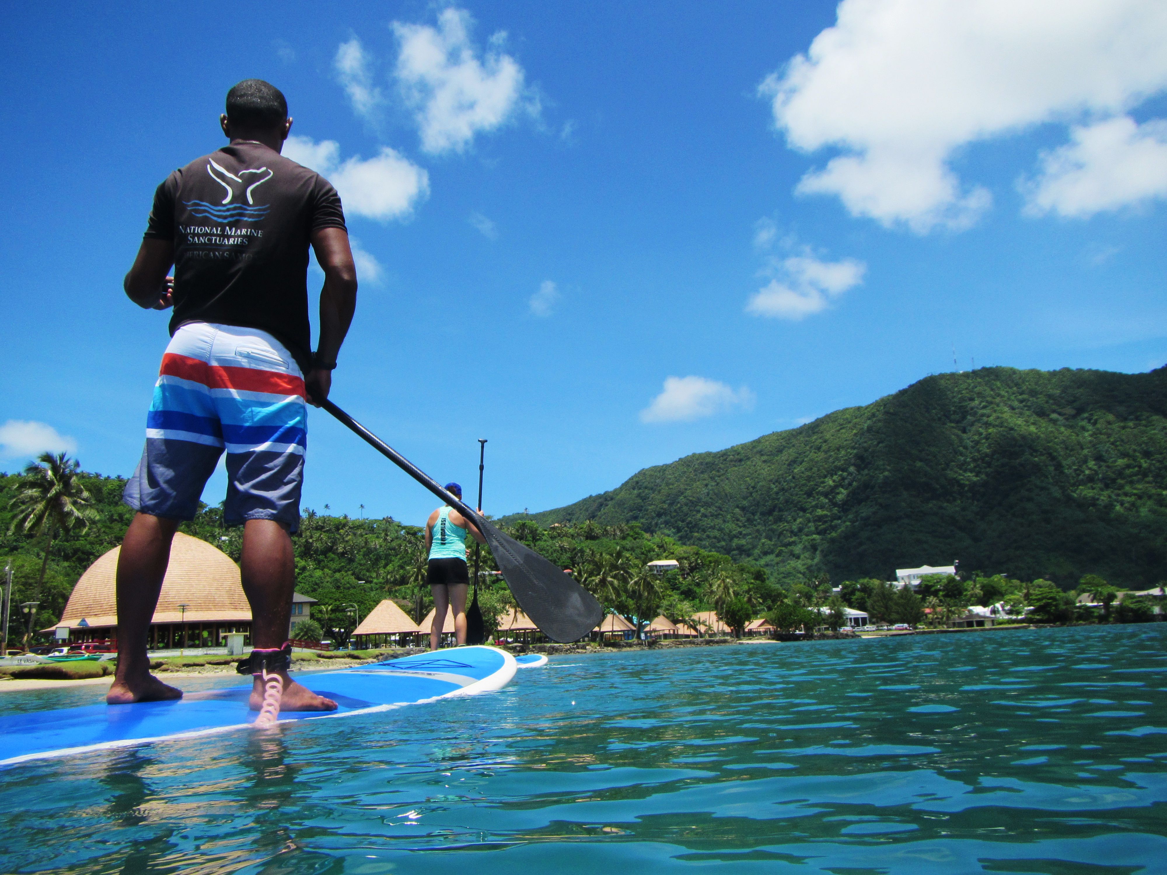 People stand-up paddleboarding at Papahānaumokuākea Marine National Monument in Hawaii, HI, USA