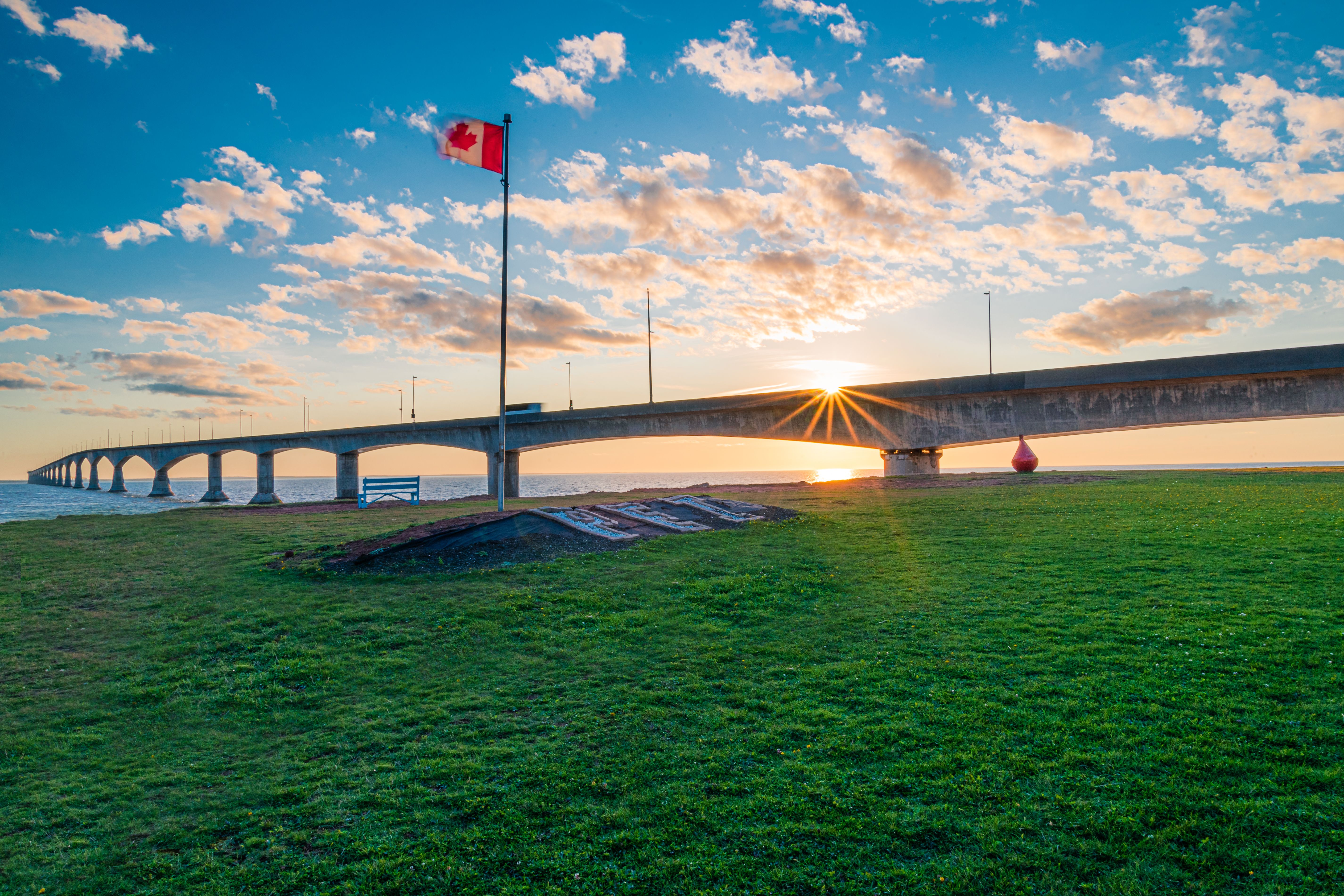 Port Borden, Prince Edward Island / Canada - September 27, 2019: The sun sets behind the Confederation Bridge.