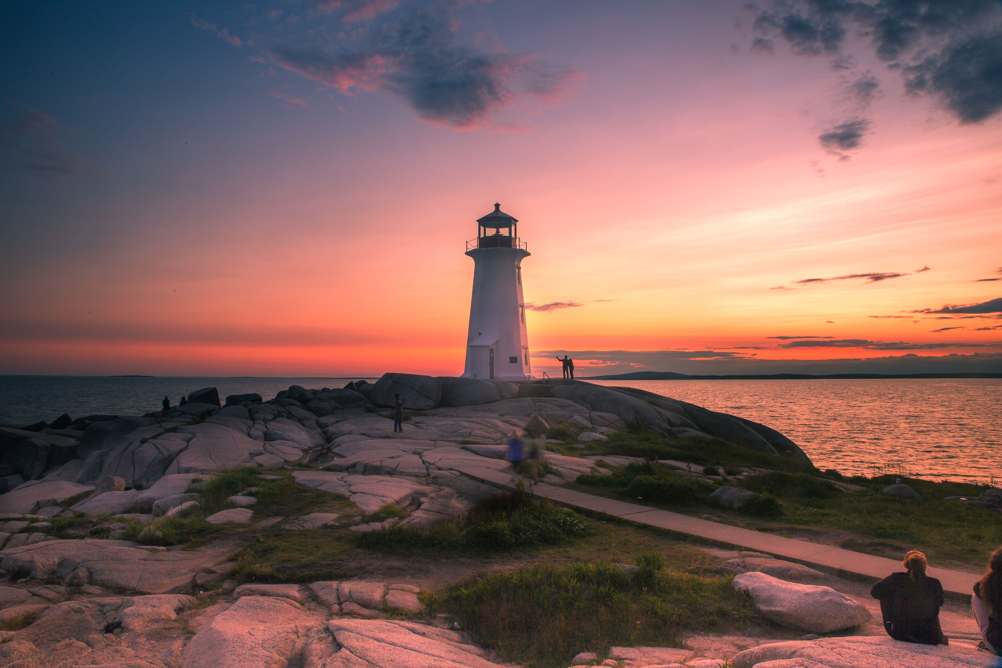 A dramatic sunset at Peggy's Cove Lighthouse near Halifax, Atlantic Coast, Nova Scotia, Canada