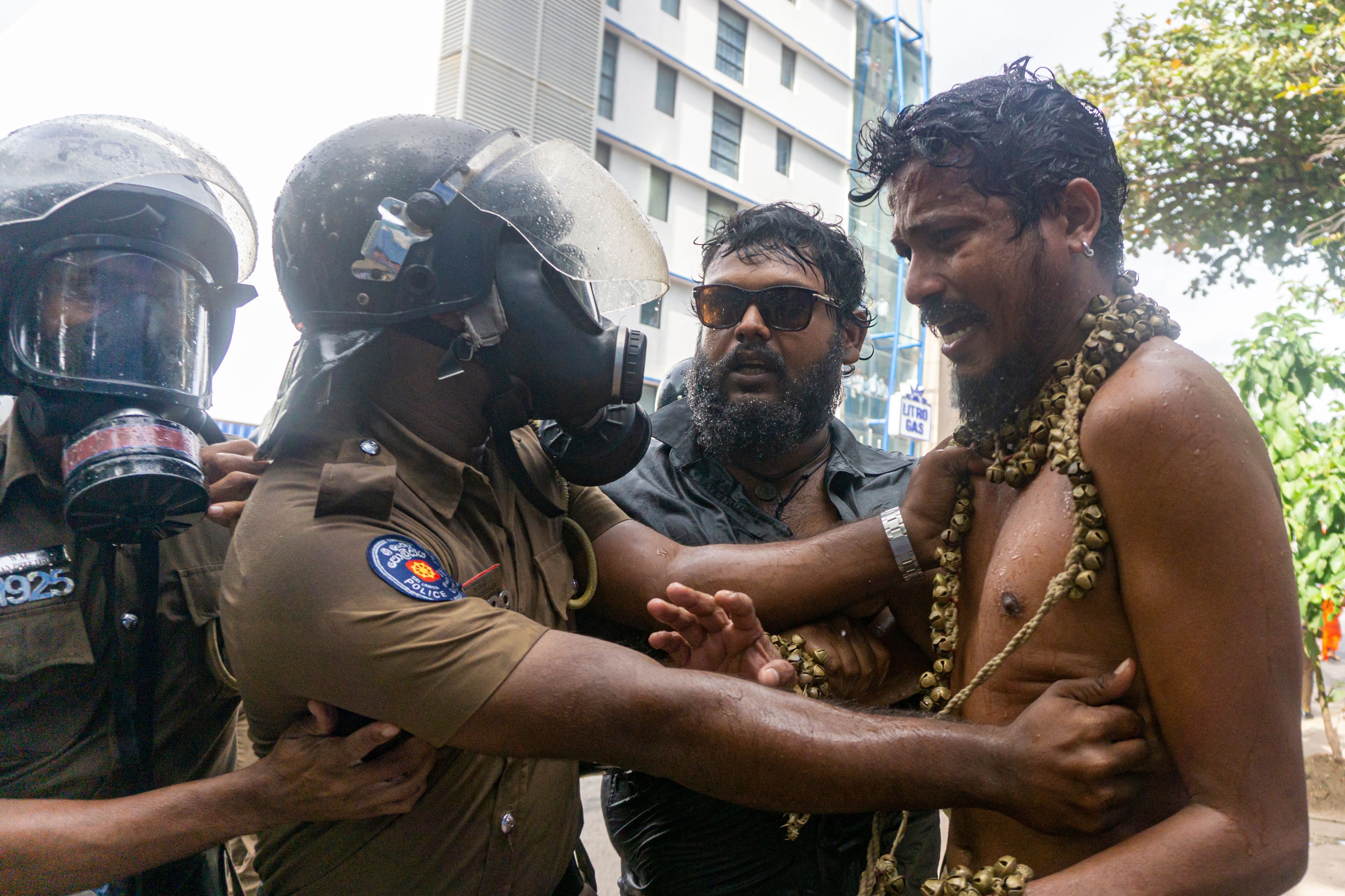 Sri Lankan Police arresting men during protests in August 2022