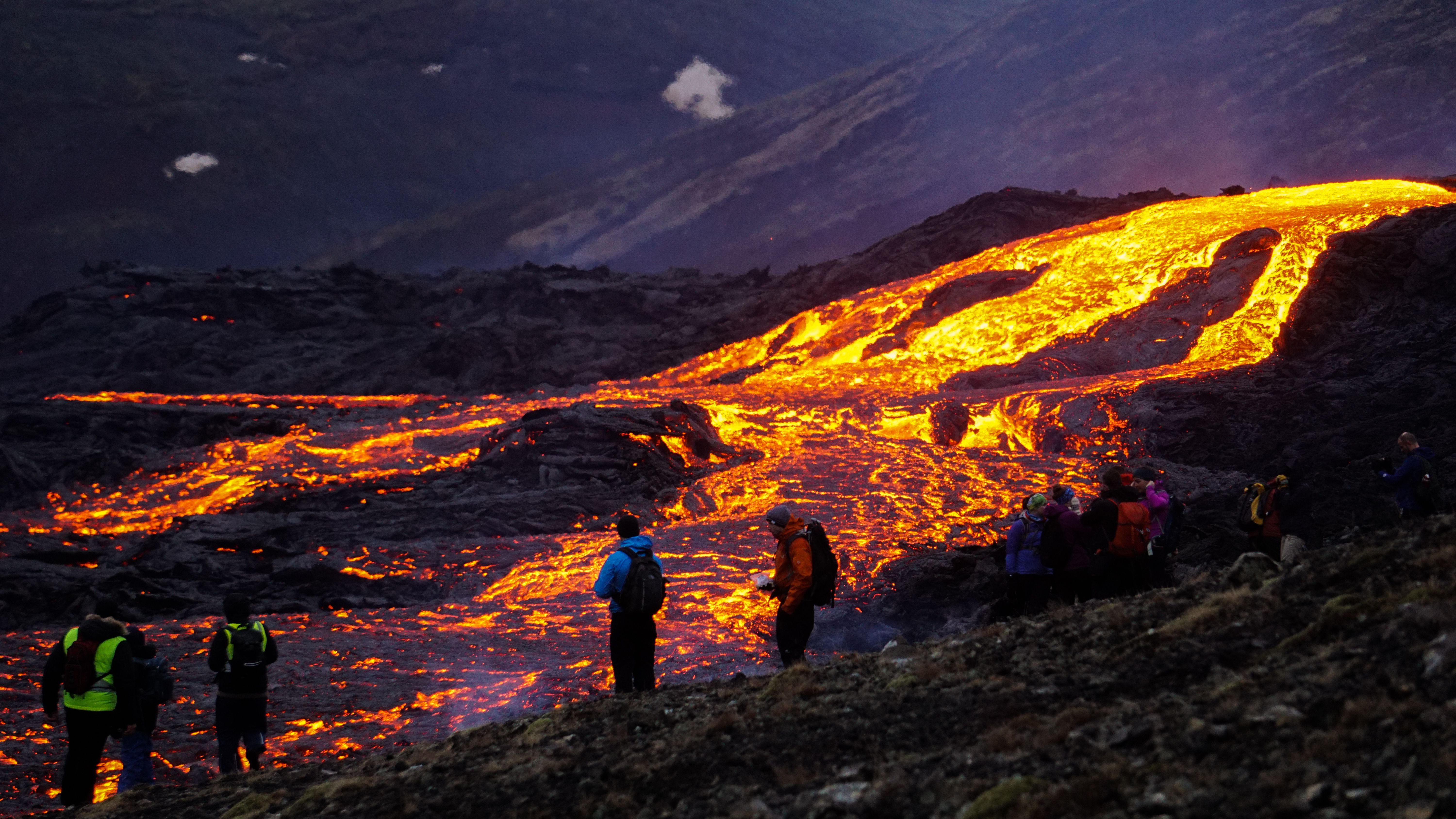 Tourists getting too close to molten hot lava flow at Grindavík, Iceland Volcanic Site