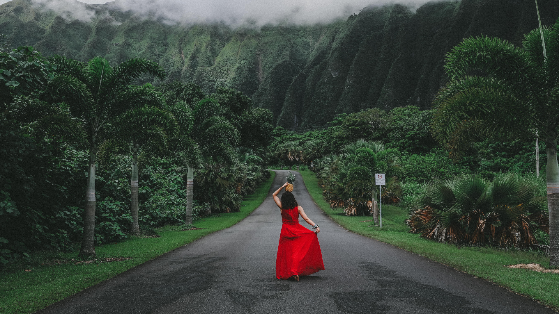 Woman in red dress walking down street in Hawaii, United States