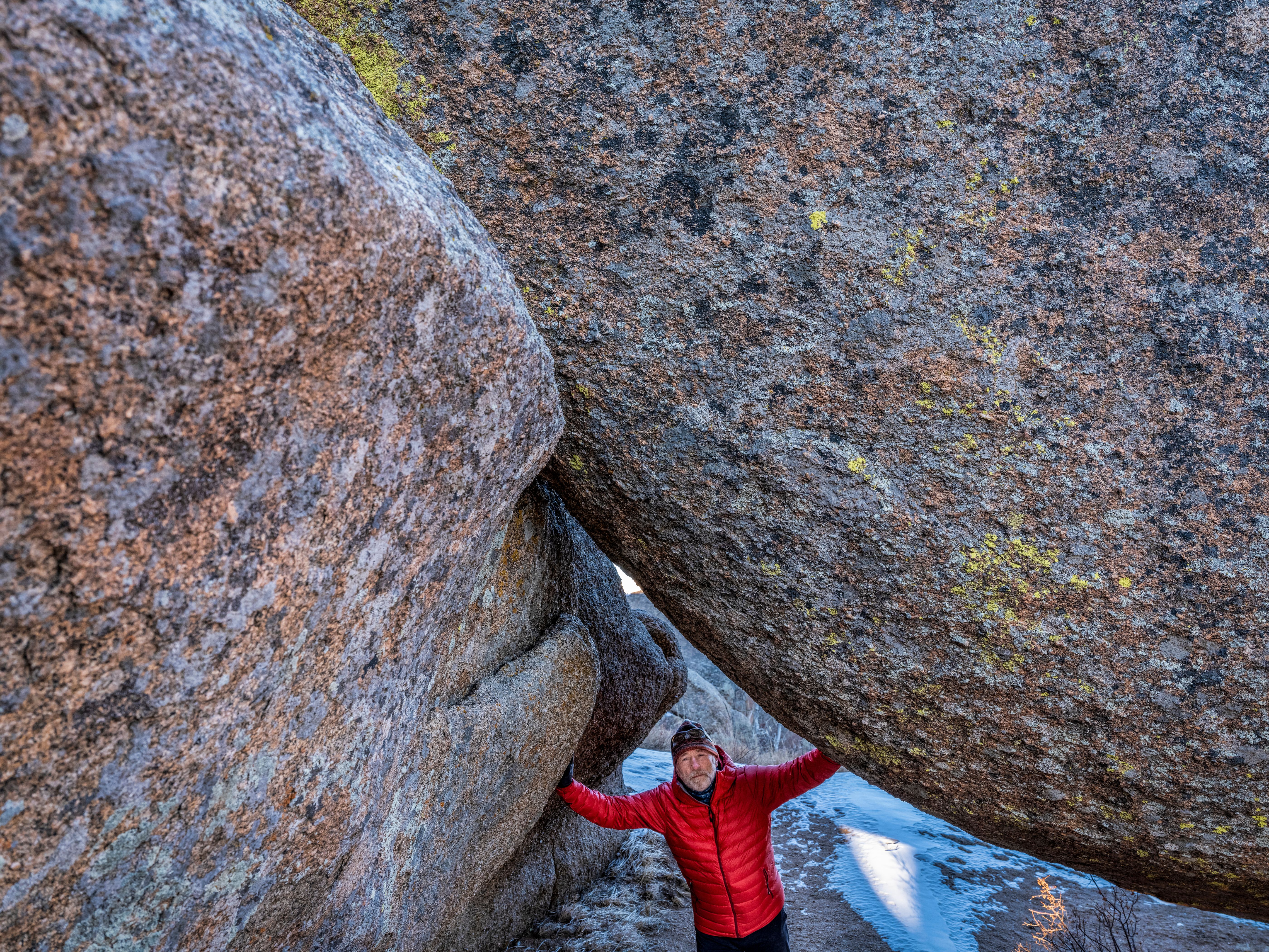 A hiker and a granite rock formation in Vedauwoo Recreation Area