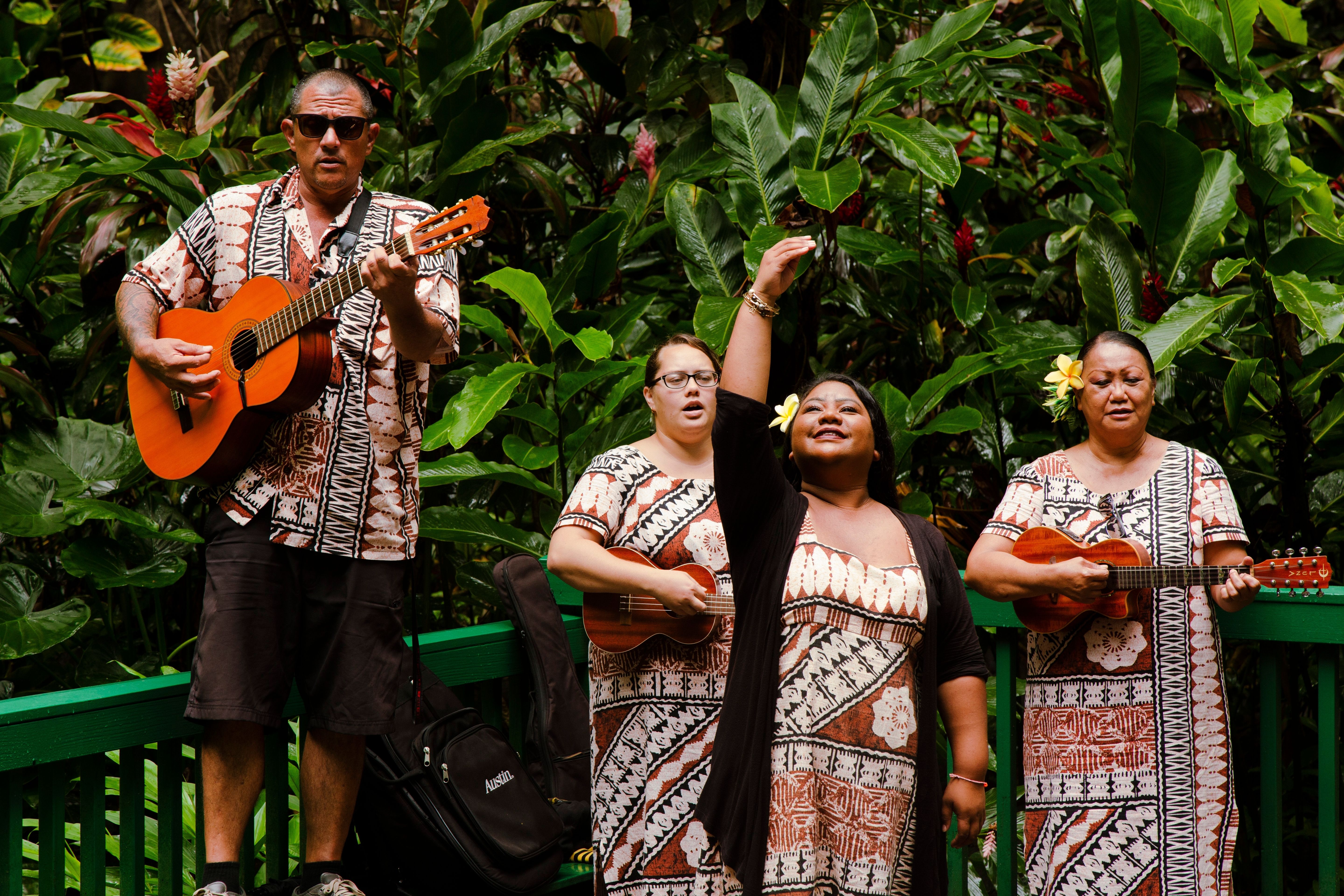 Musicians playing music and doing hula at Smith's Fern Grotto Tour in Kauai, Hawaii.