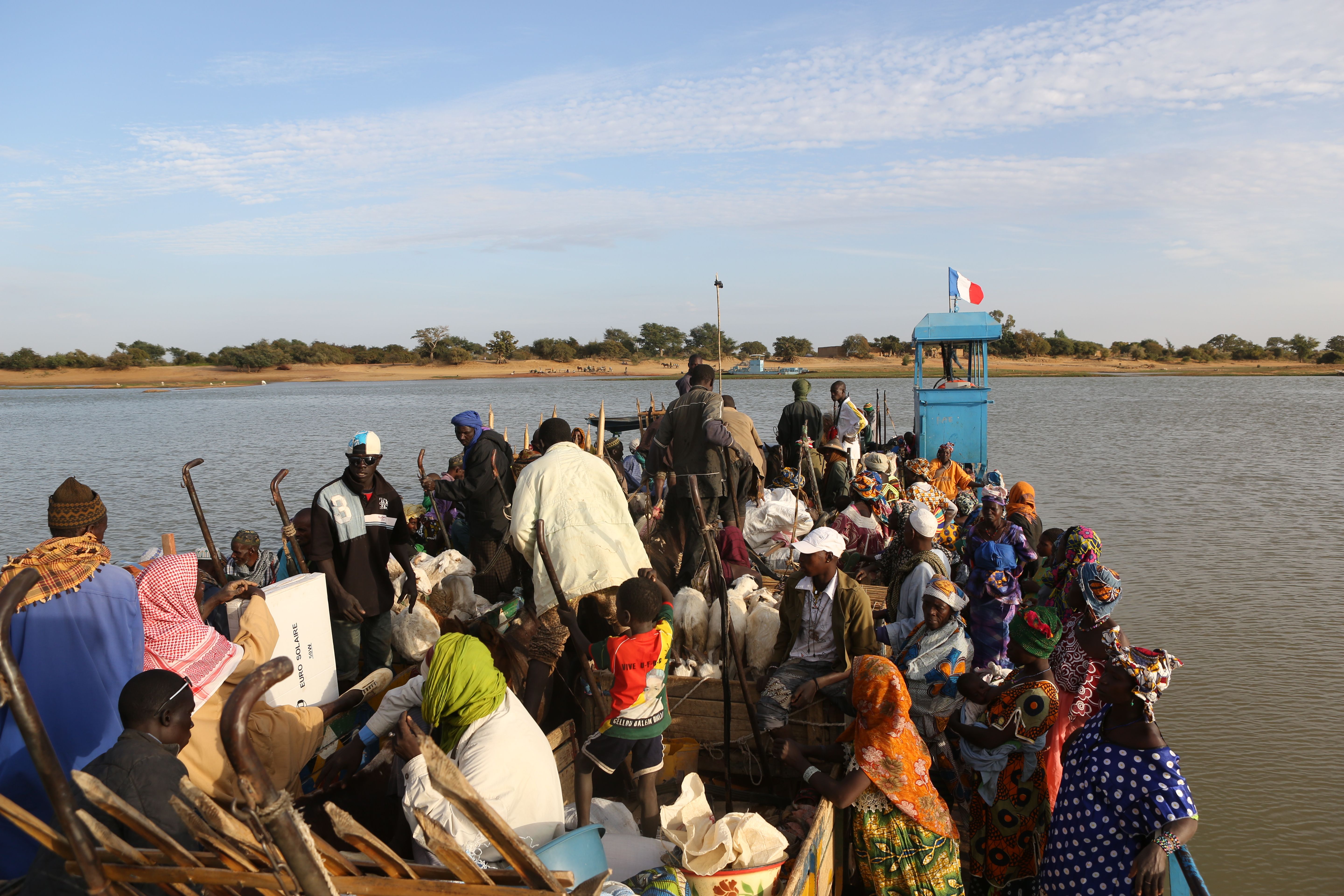January 28, 2013 people riding a ferry with their horse from the river in Djenne, Mali