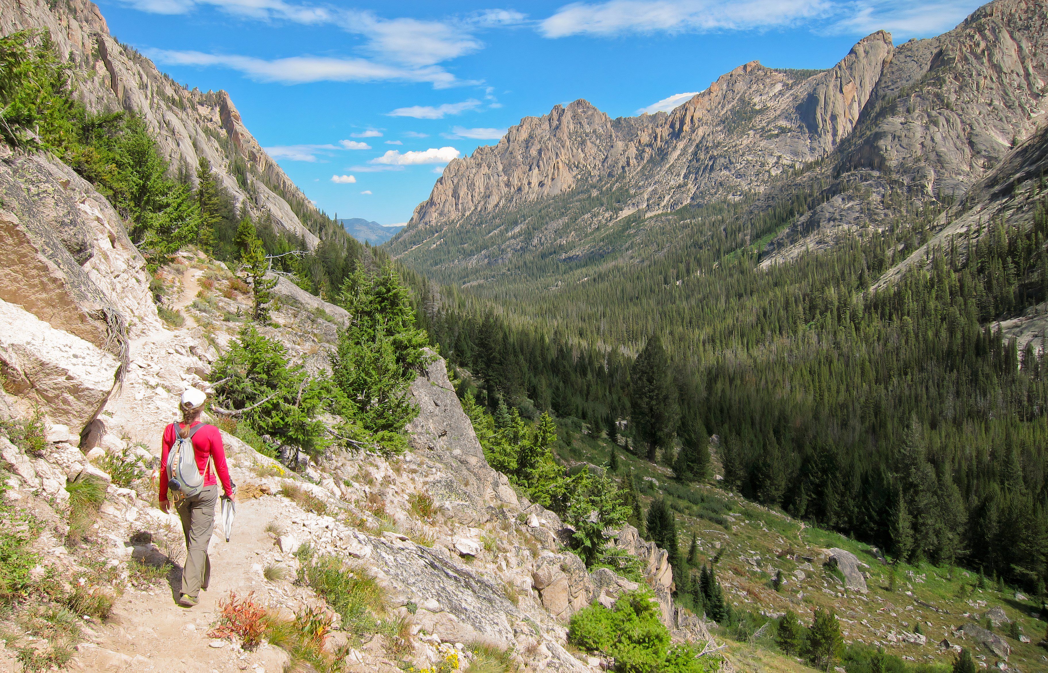 Hiker and Redfish Canyon from Alpine Lake trail in Sawtooth Wilderness, Idaho