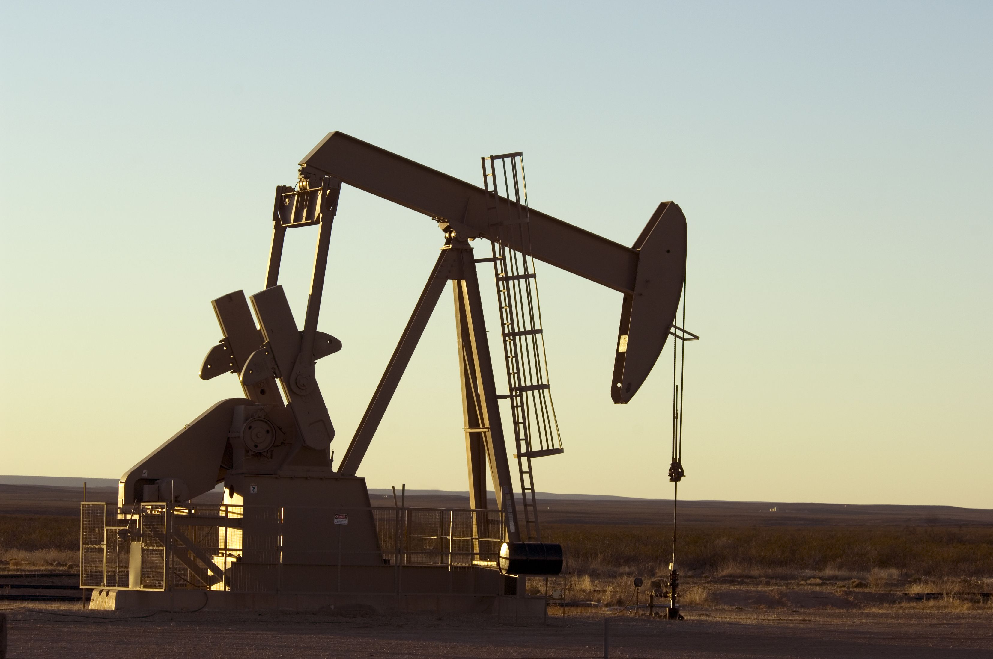 Working oil pump in rural Texas at sunset