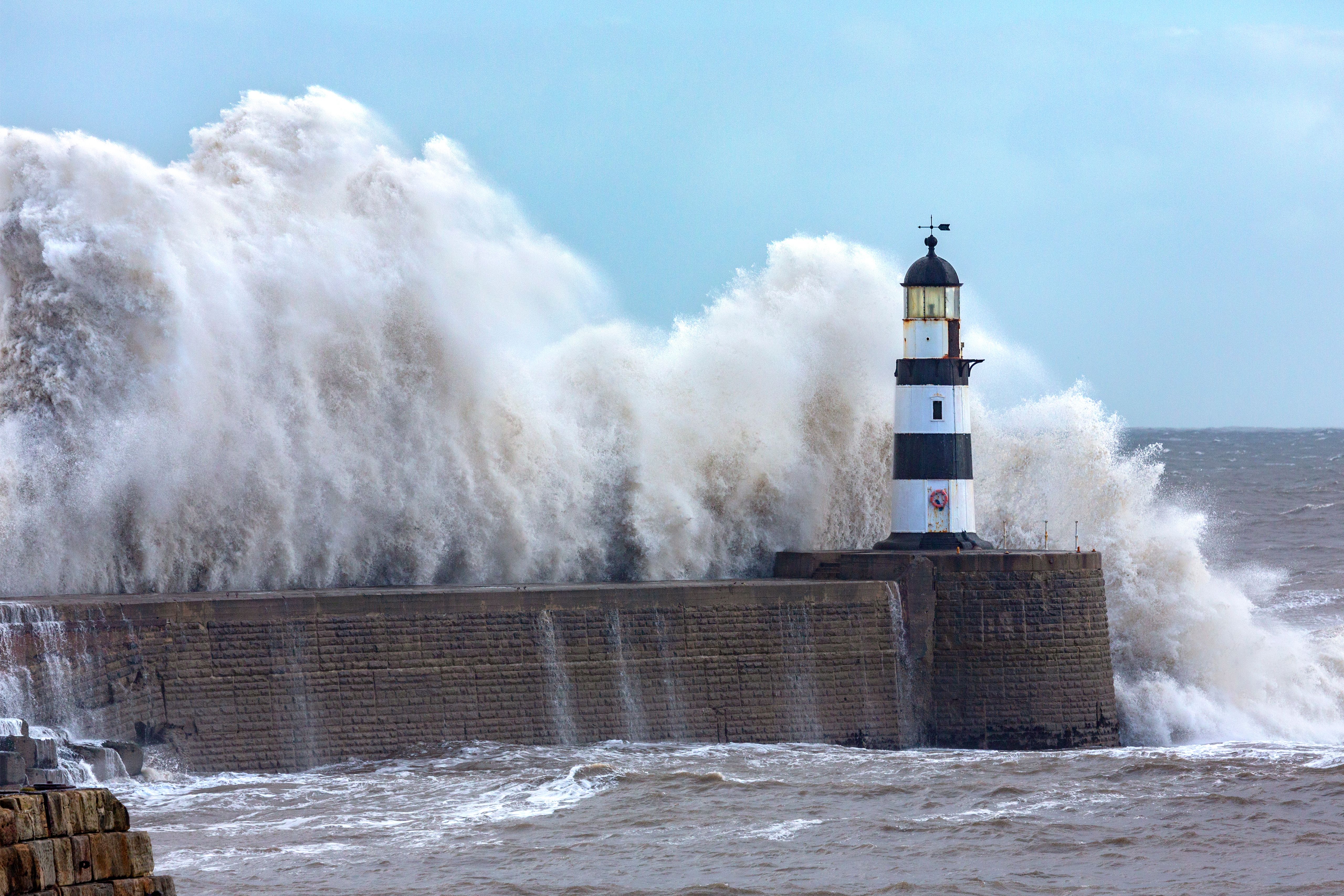 Waves crashing over Seaham Lighthouse on the northeast coast of England