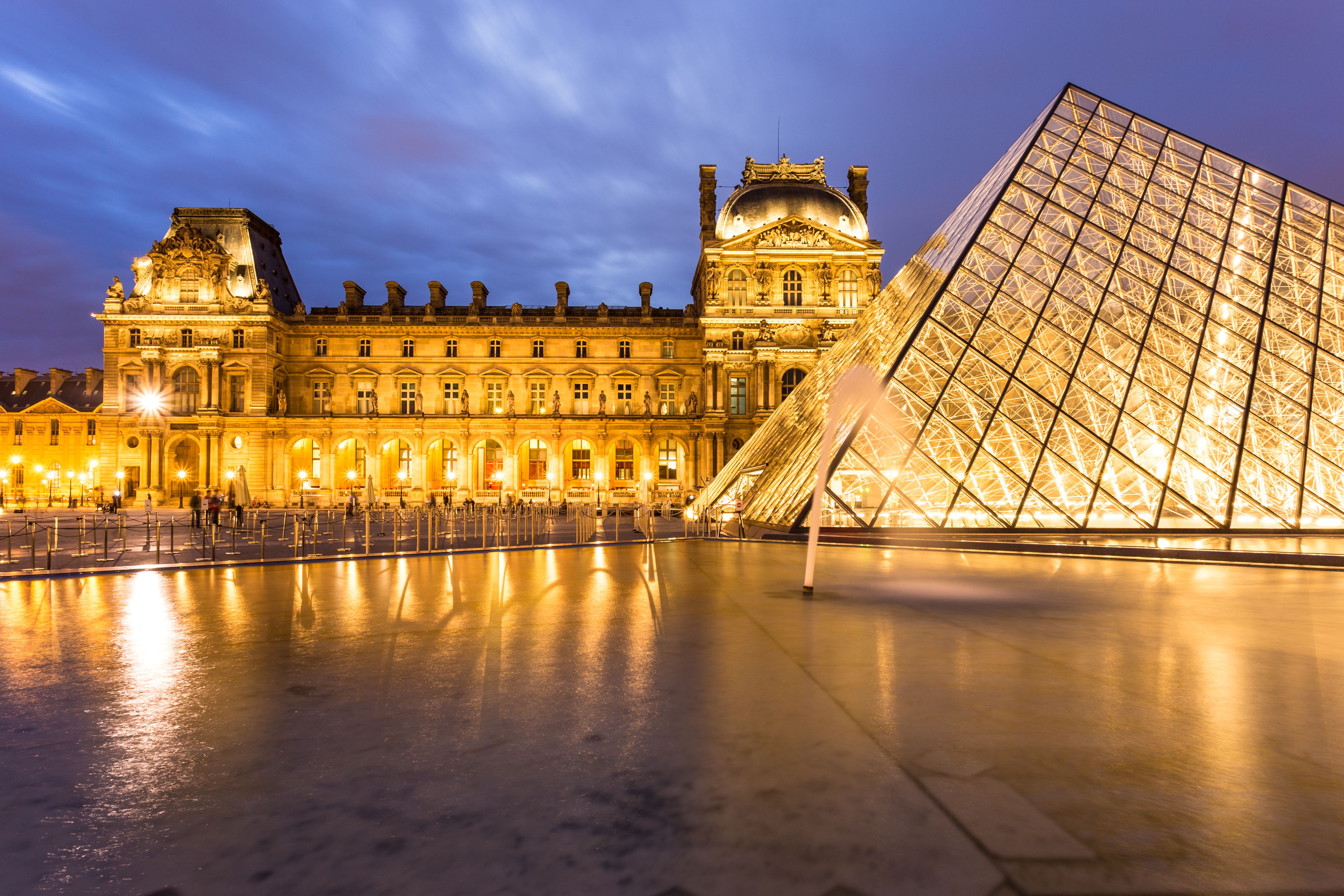 PARIS, FRANCE - AUGUST 4, 2016 - The Louvre Palace at night with its famous pyramid in Paris, France