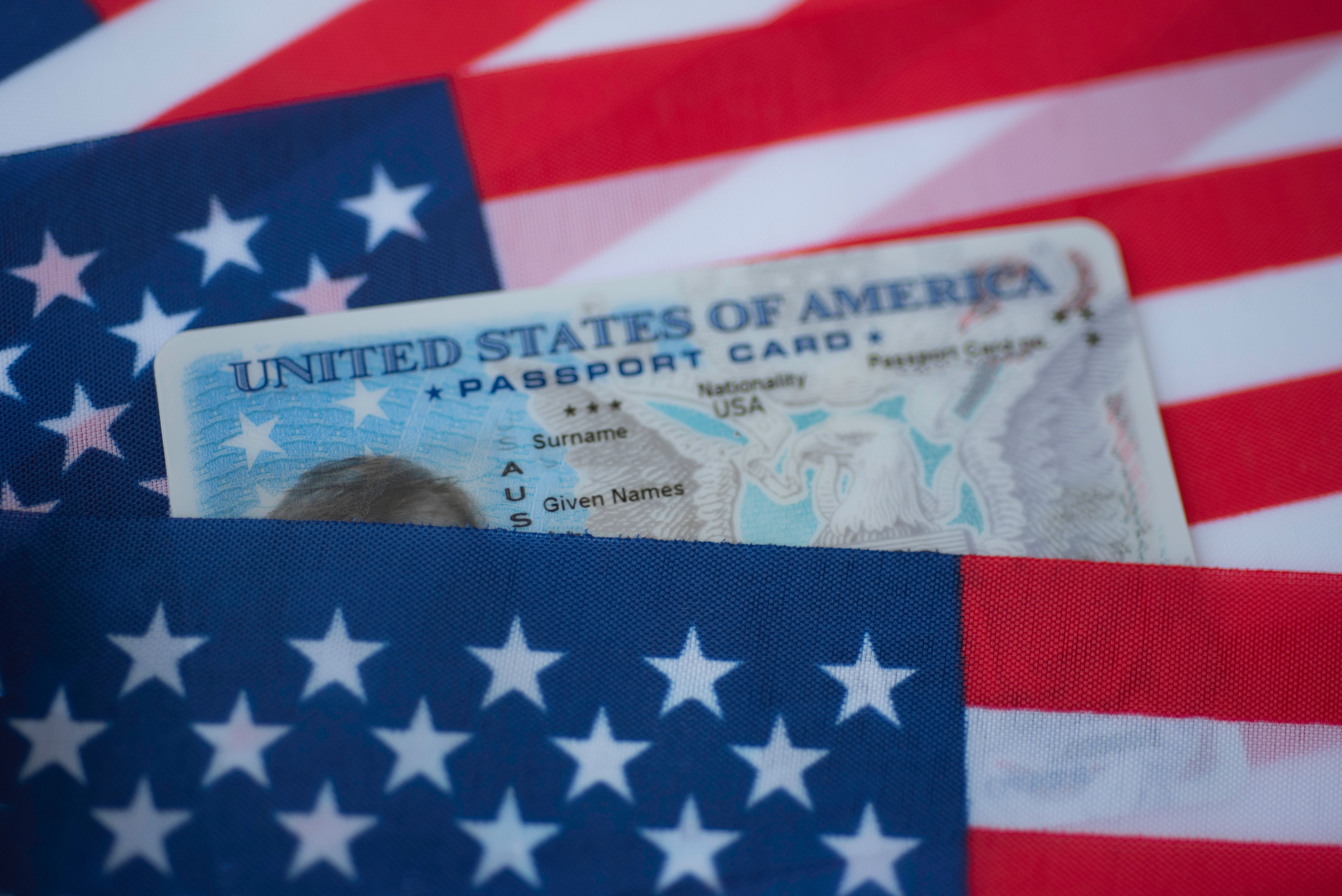 Passport card between American flags