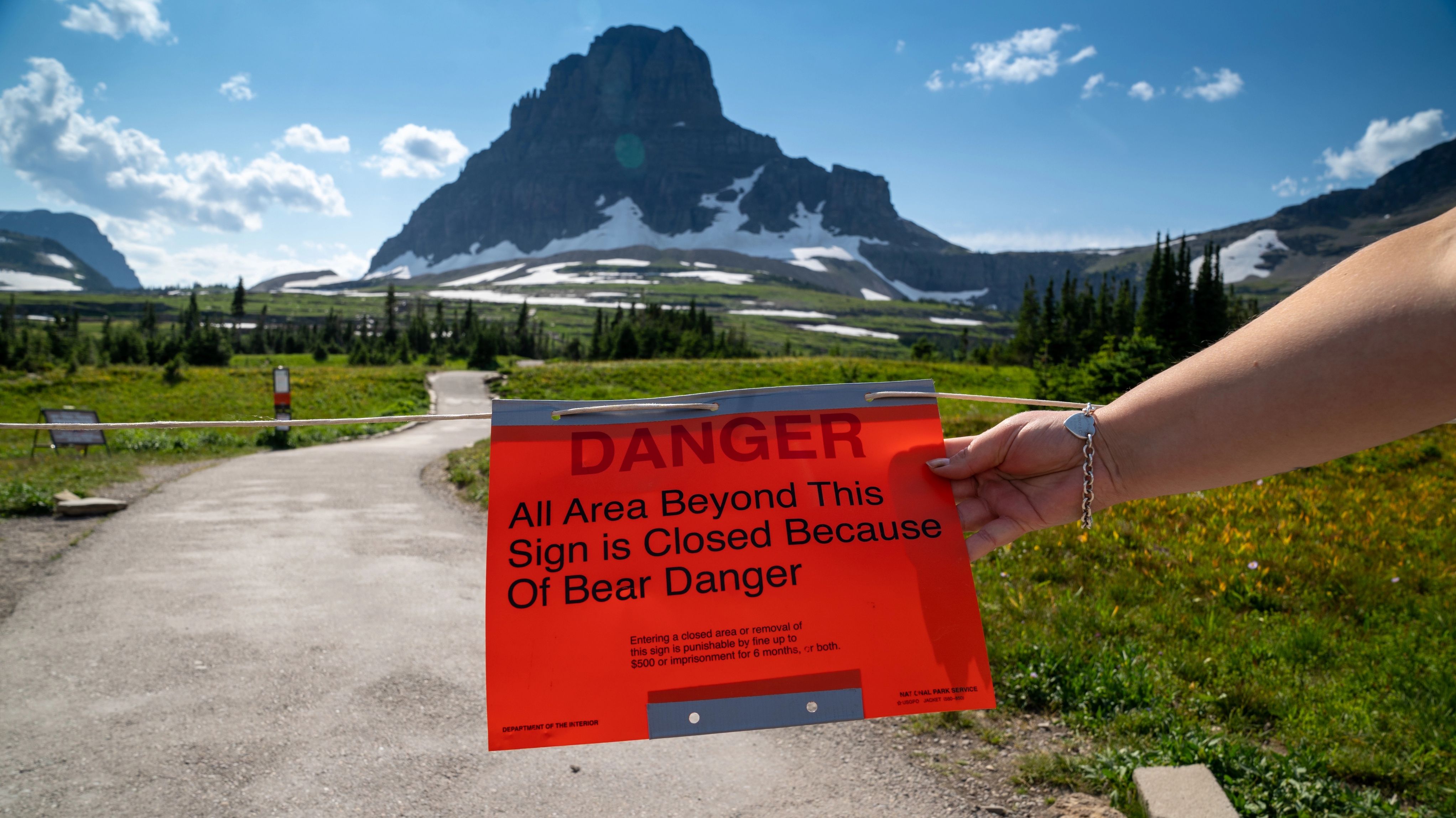 Sign at the Hidden Lake trailhead at Logan Pass in Glacier National Park, noting the trail is closed