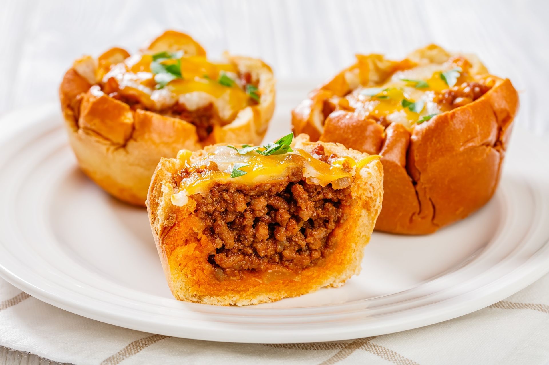 Mini sloppy Joe cups filled with savory seasoned beef and topped with melted cheese.