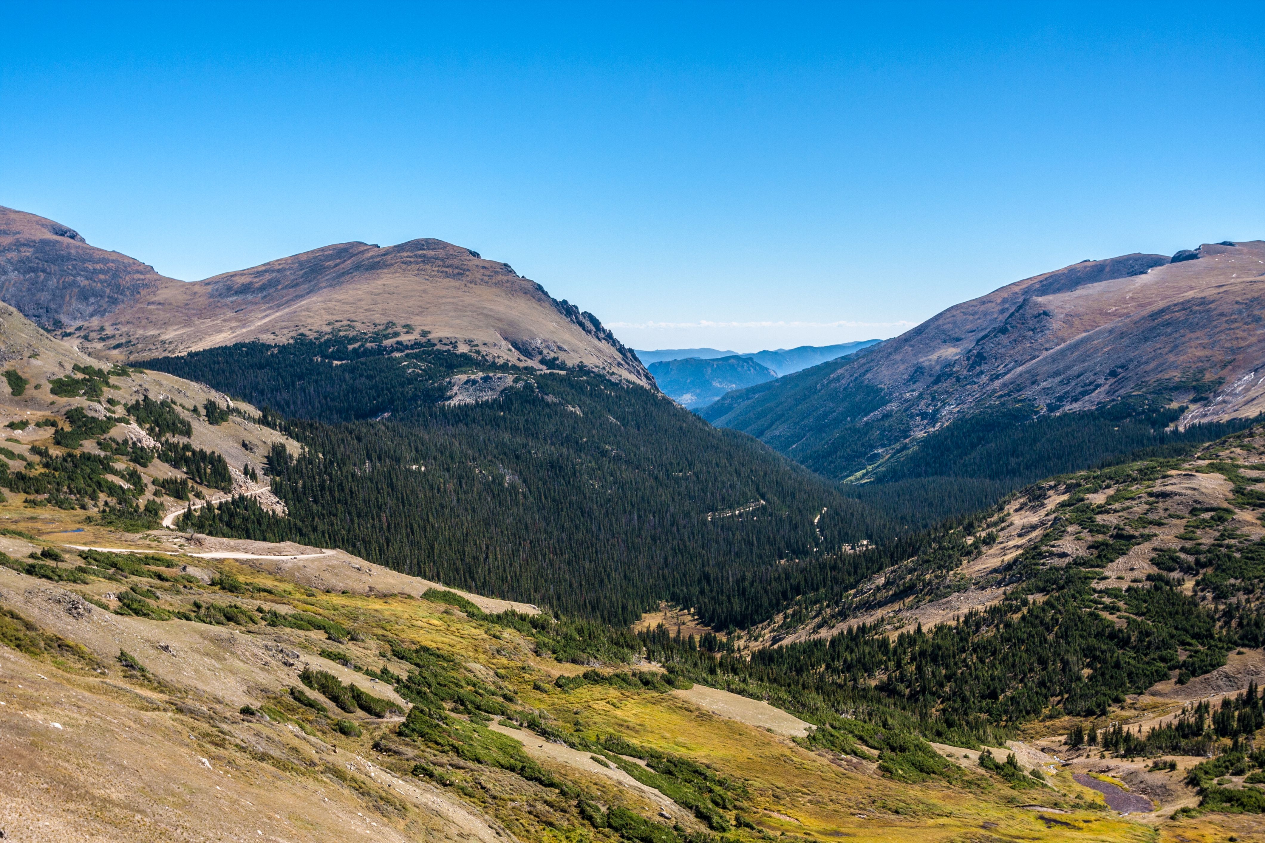 Scenic view of mountains and distant plains from top of Trail Ridge Road in Rocky Mountain National Park, Colorado