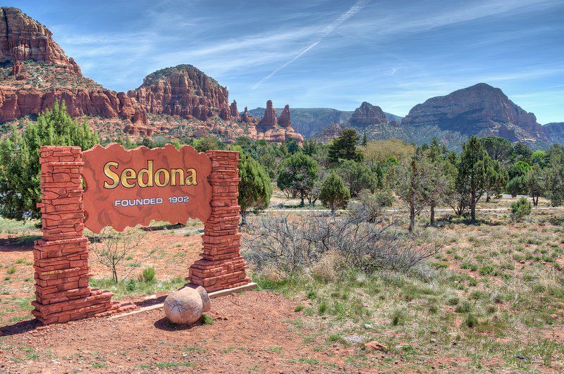 Welcome Sign To Sedona, Arizona, With A Scenic Background