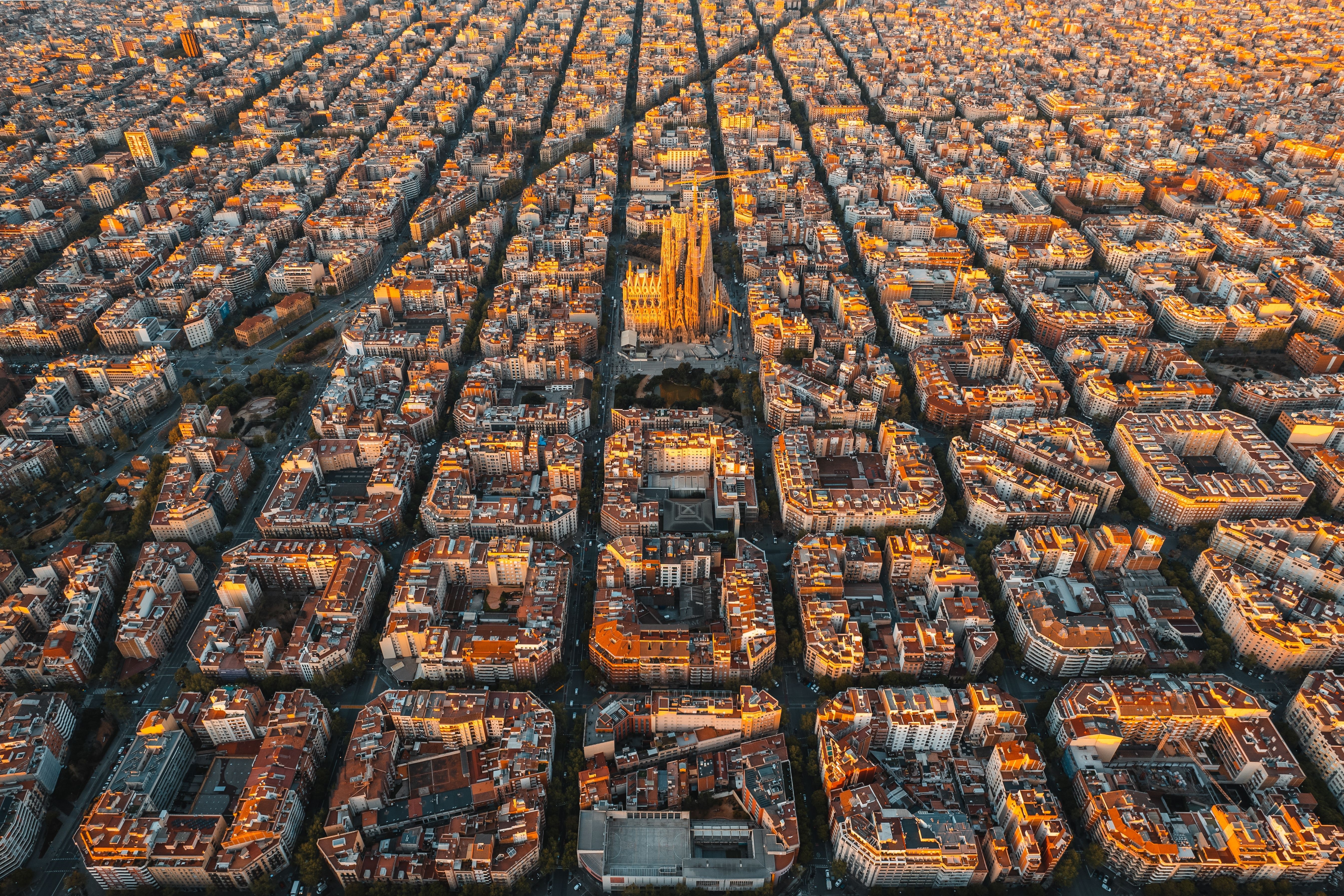 Aerial view of Barcelona Eixample residential district and Sagrada Familia Basilica at sunrise