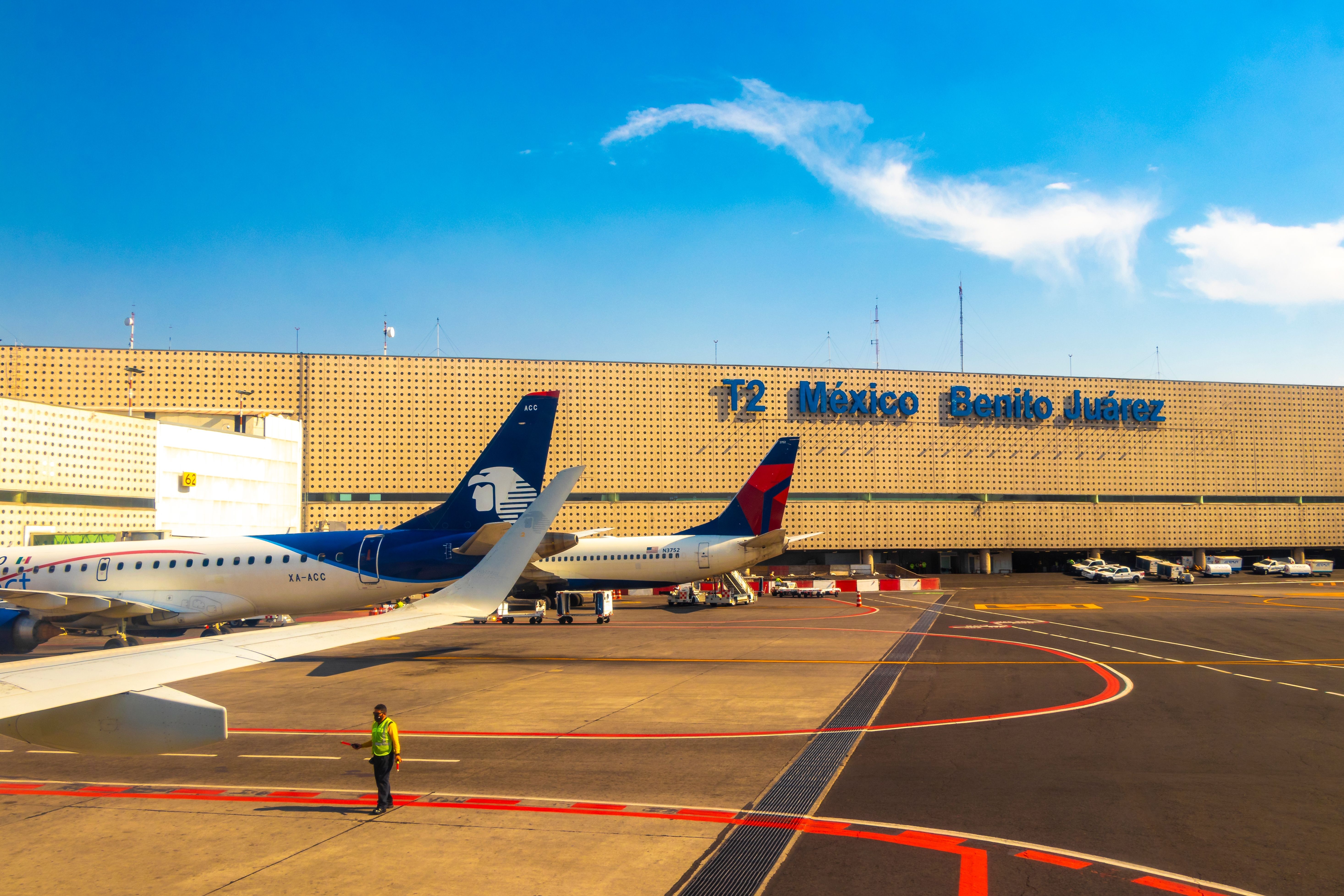 Aircraft at the airport Building and runway Aeropuerto Internacional Benito Juarez in Mexico City Mexico