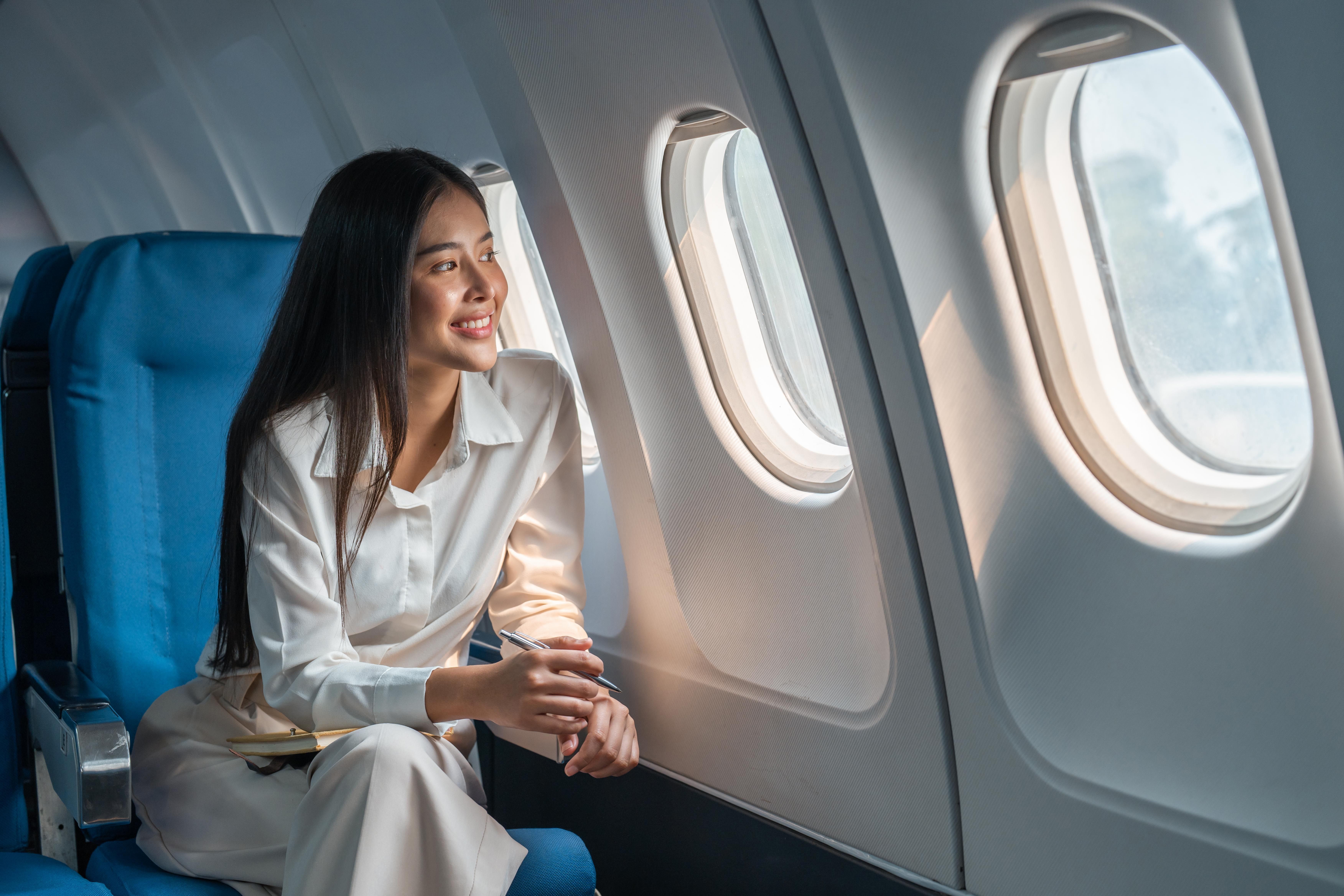 Woman staring out the window of a plane