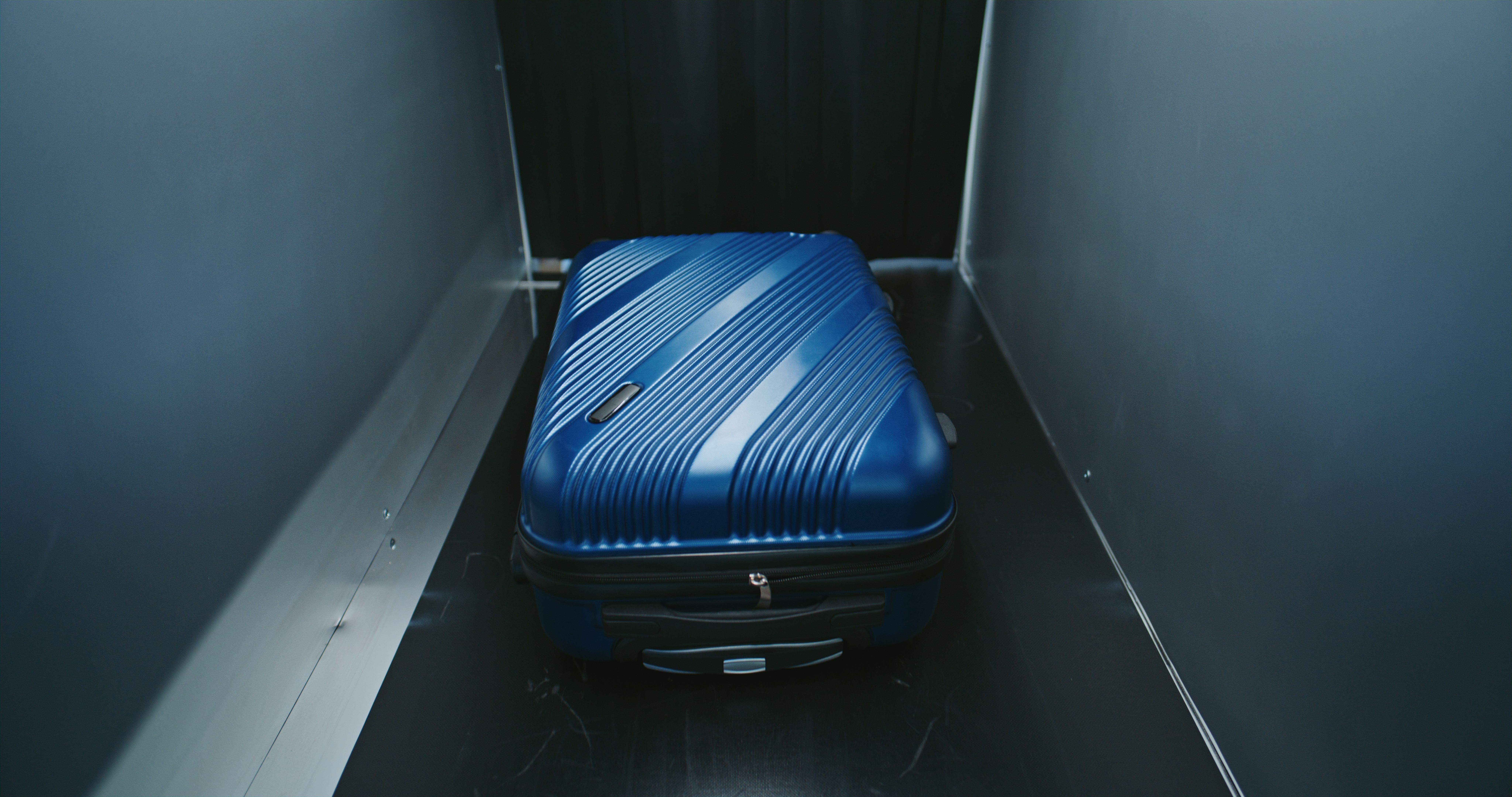 A view of a baggage screening procedure at a security checkpoint in an Airport Terminal.
