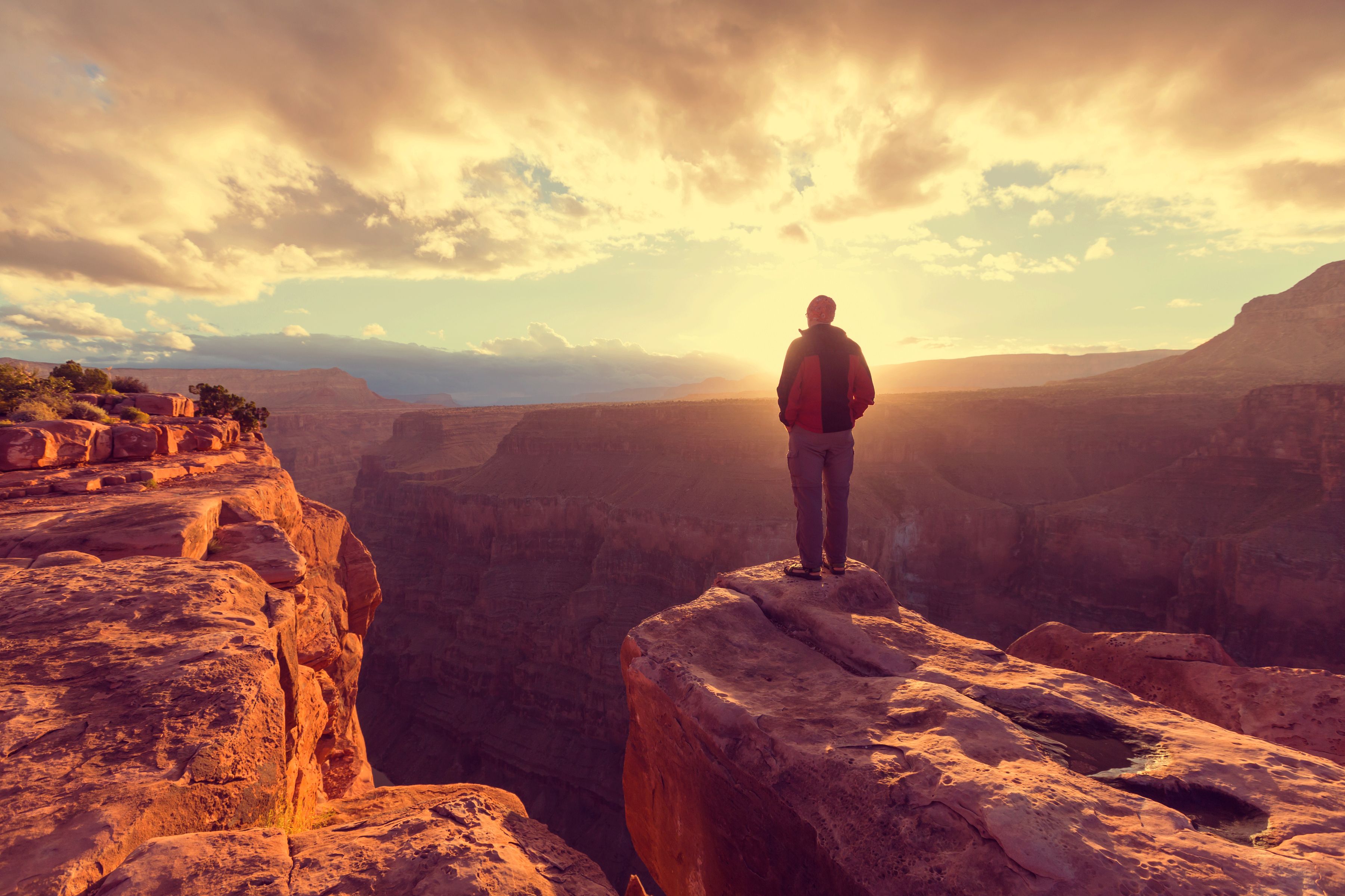 Hiker enjoying a sunrise view in Grand Canyon National Park, Arizona